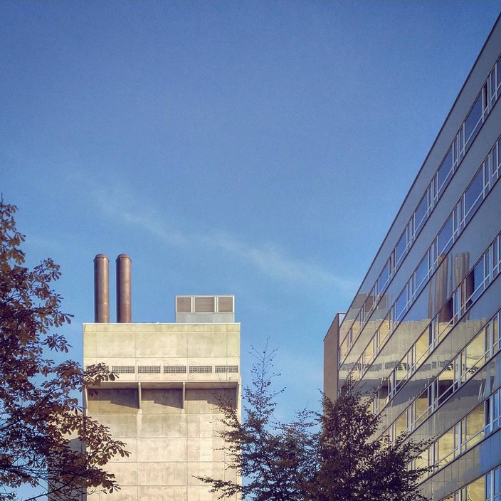 Architecture at Ullevål Hospital, Oslo. Concrete building reflected in a glass building.