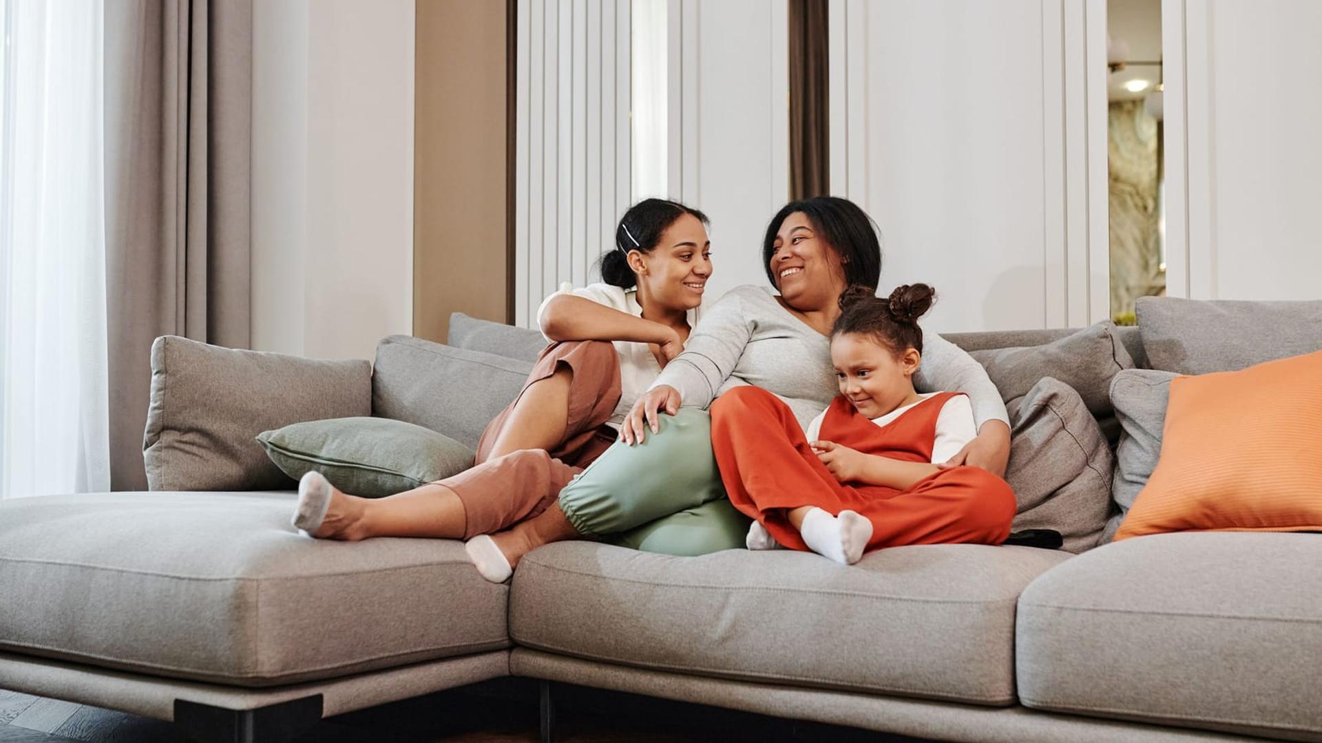 A family relaxing in a clean modern living room, typical of Daybreak homes
