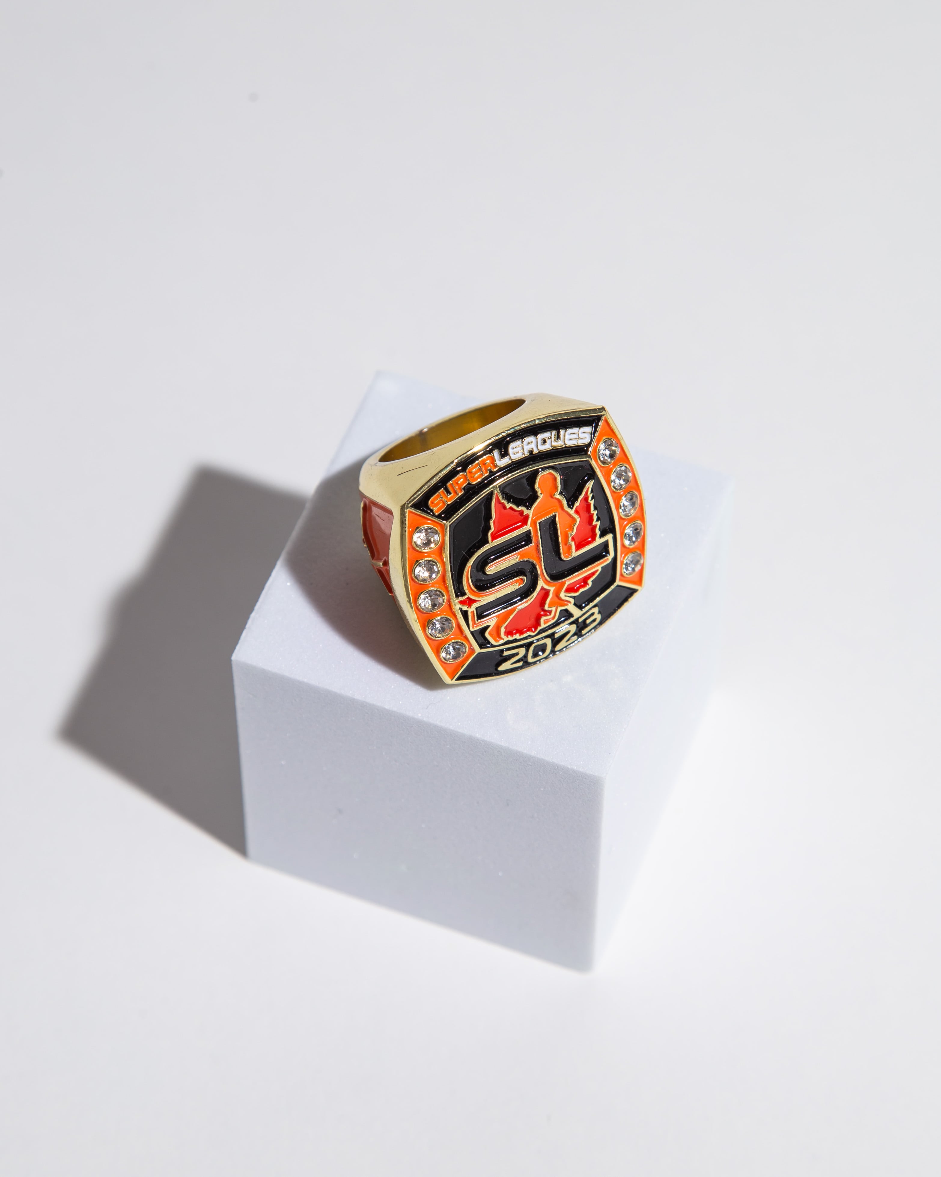 Personalized championship ring with sparkling details and bold Super Leagues 2023 logo. Perfect for high-level tournament winners.