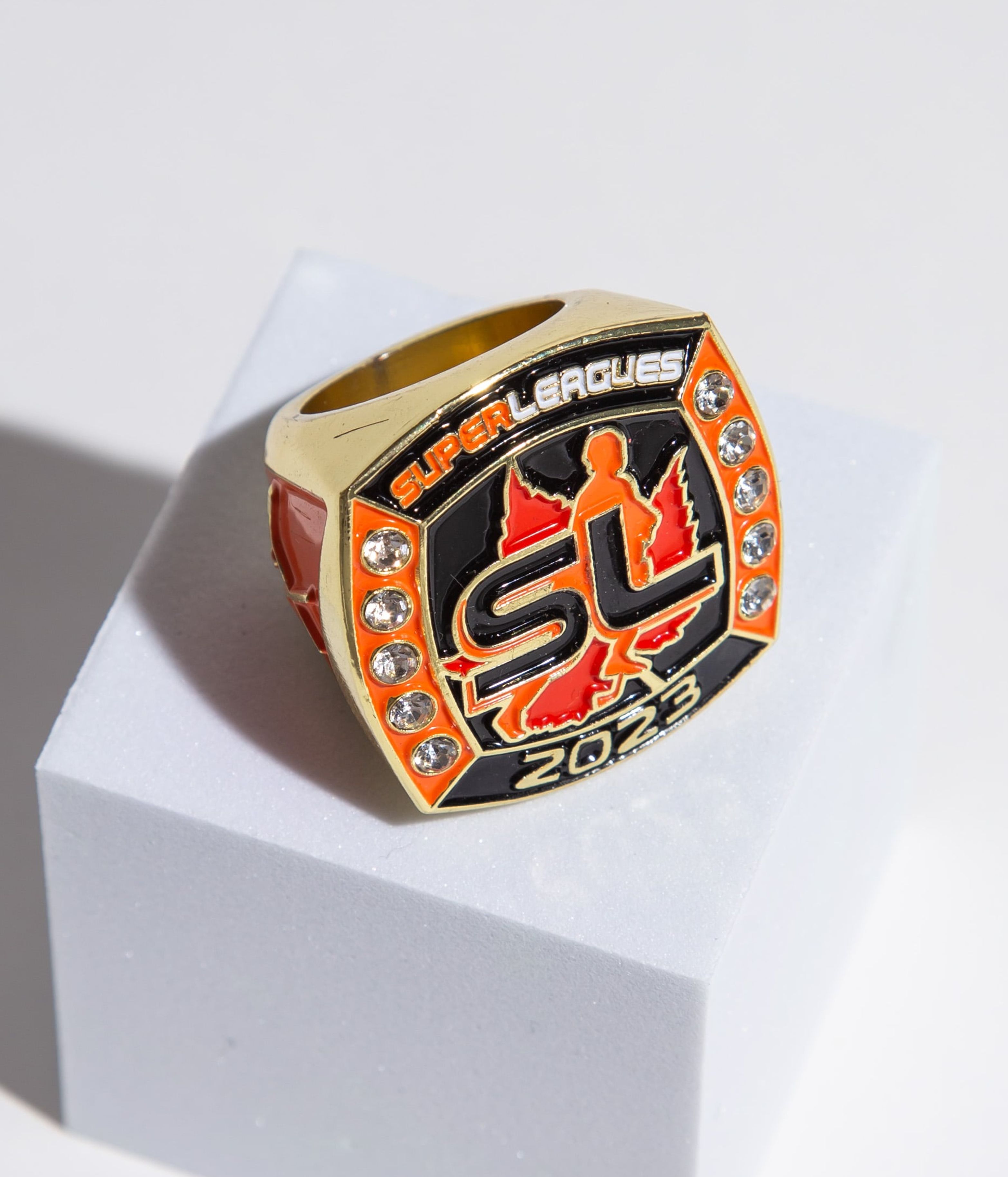 Personalized championship ring with sparkling details and bold Super Leagues 2023 logo. Perfect for high-level tournament winners.
