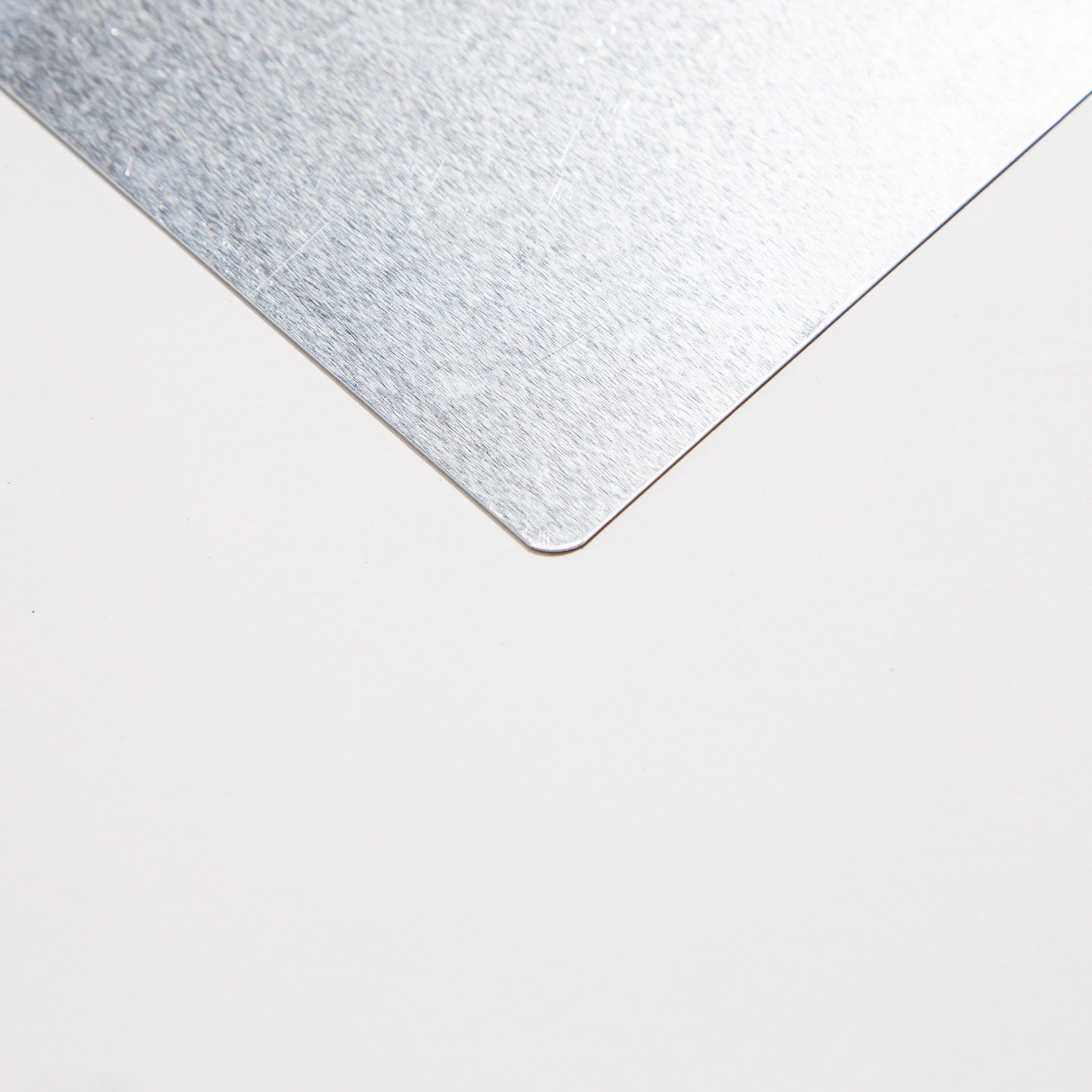 Close-up of a brushed metal corner on a white background.