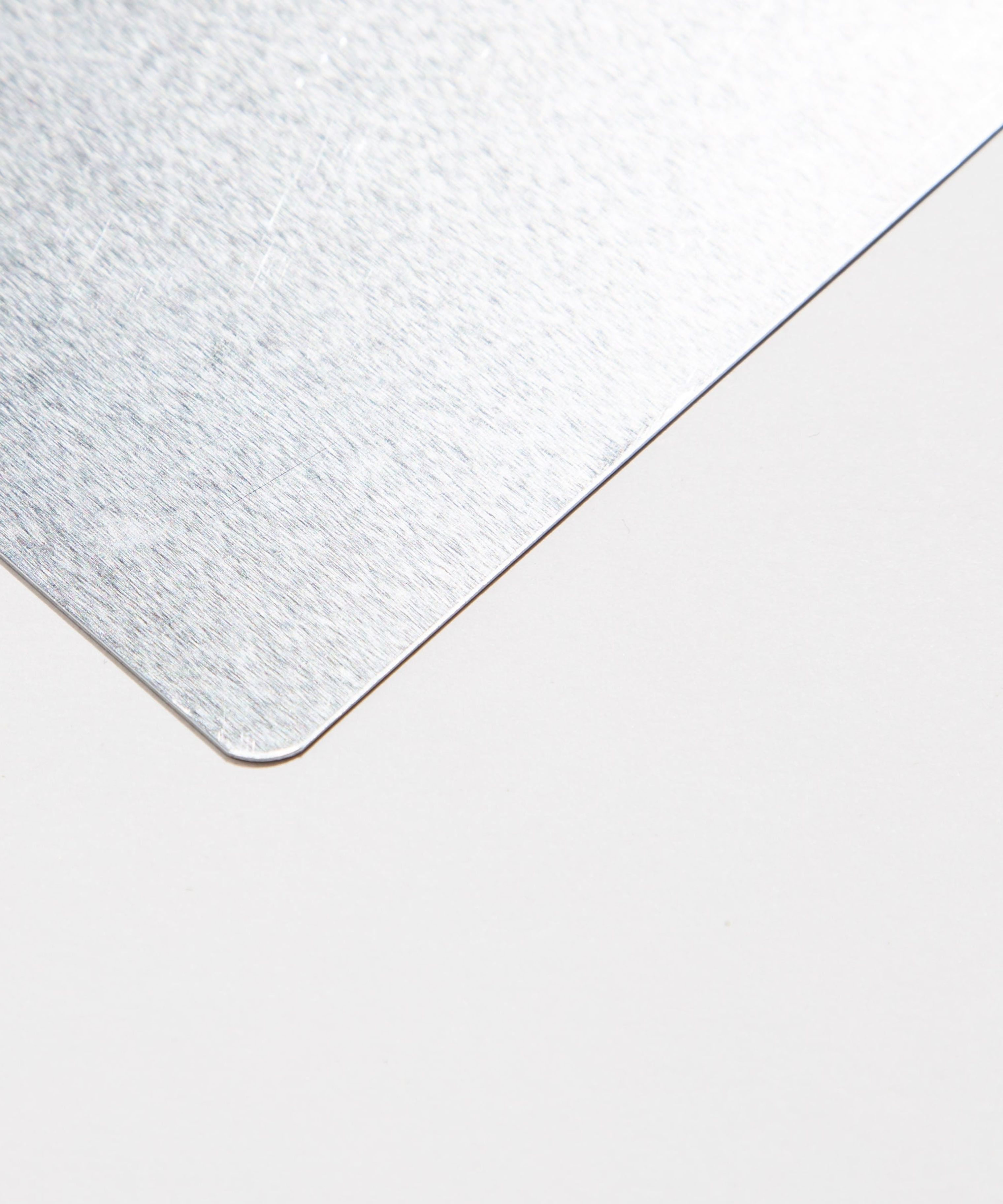 Close-up of a brushed metal corner on a white background.