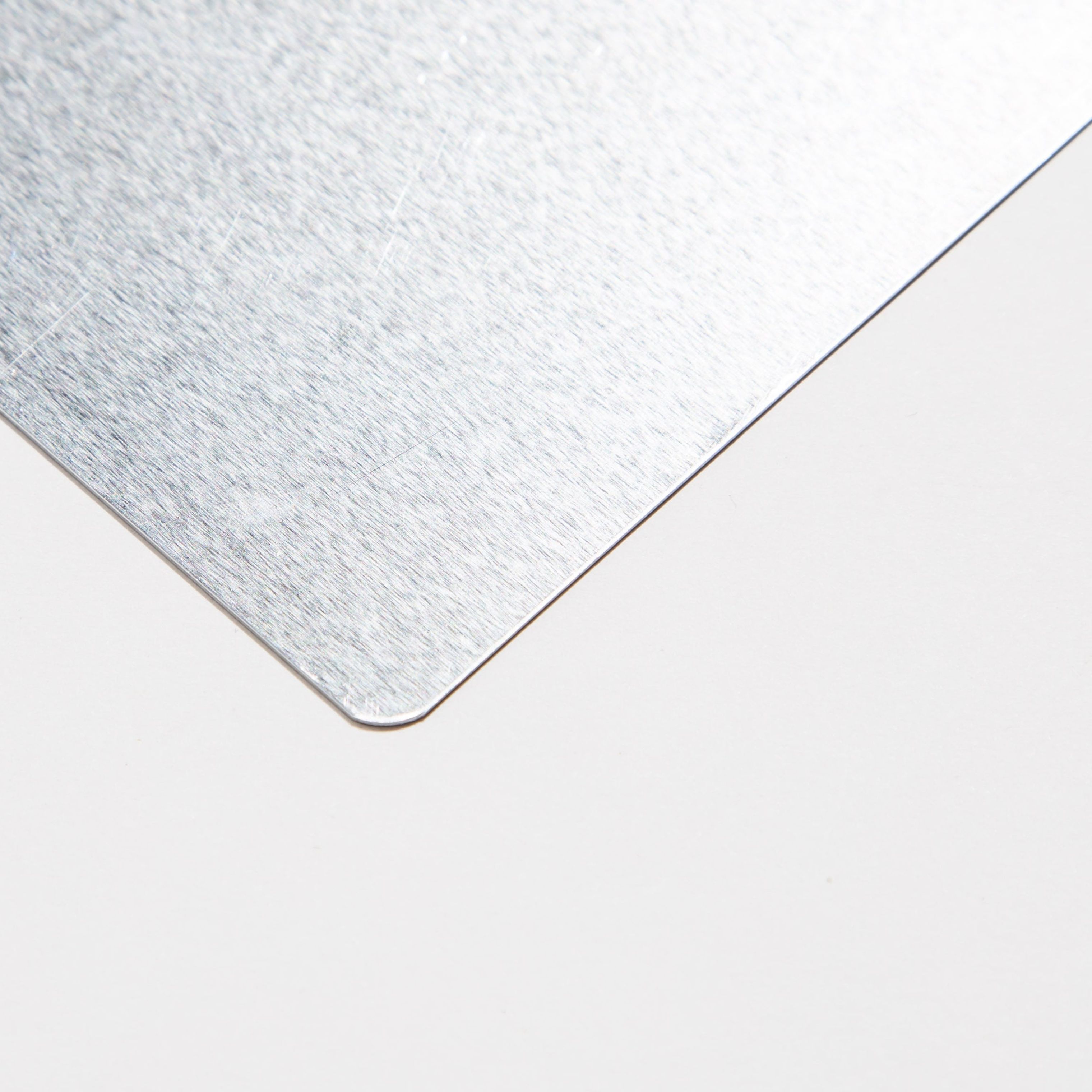 Close-up of a brushed metal corner on a white background.