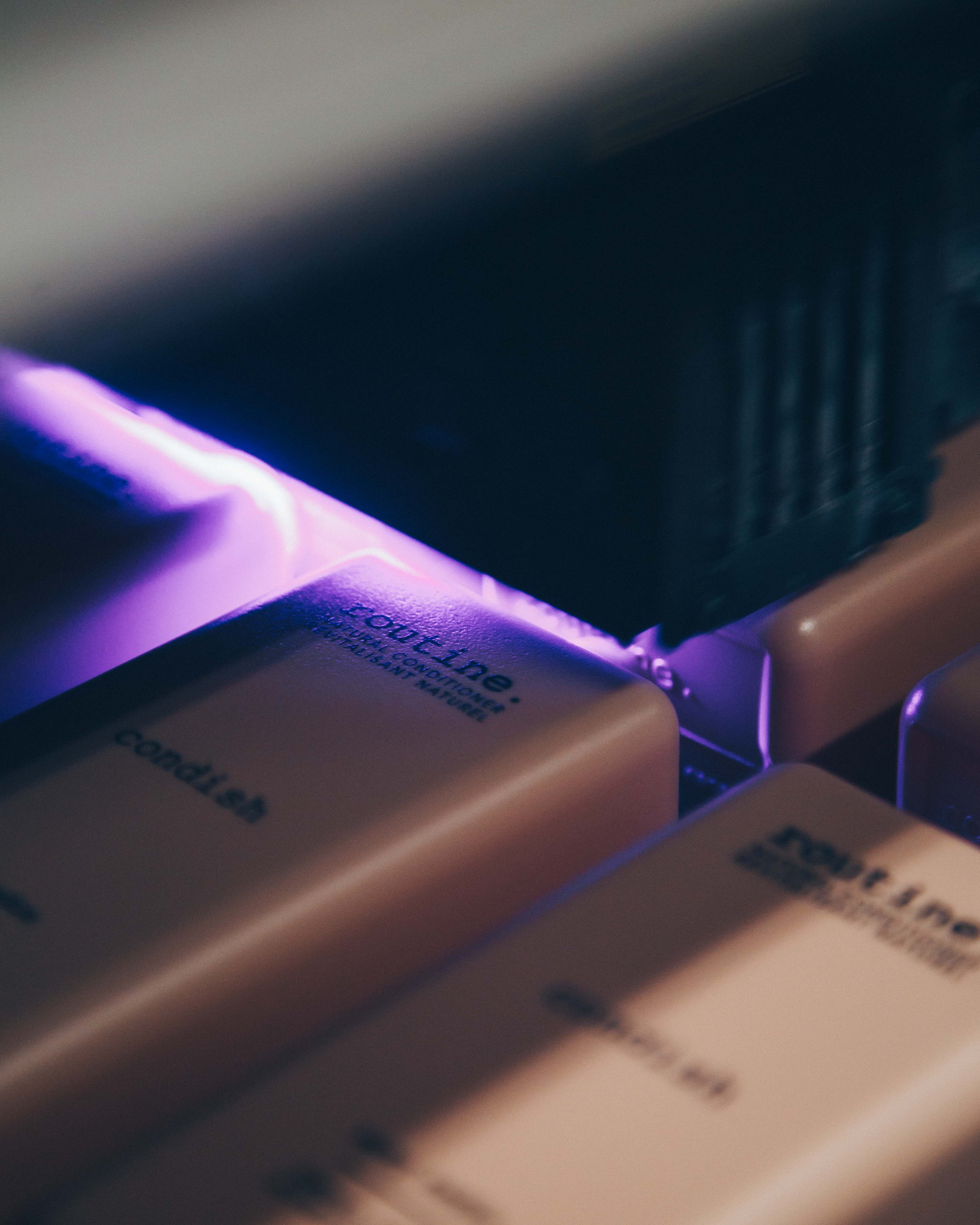 Close up of a digital printer printing a label on a Routine-branded shampoo bottle