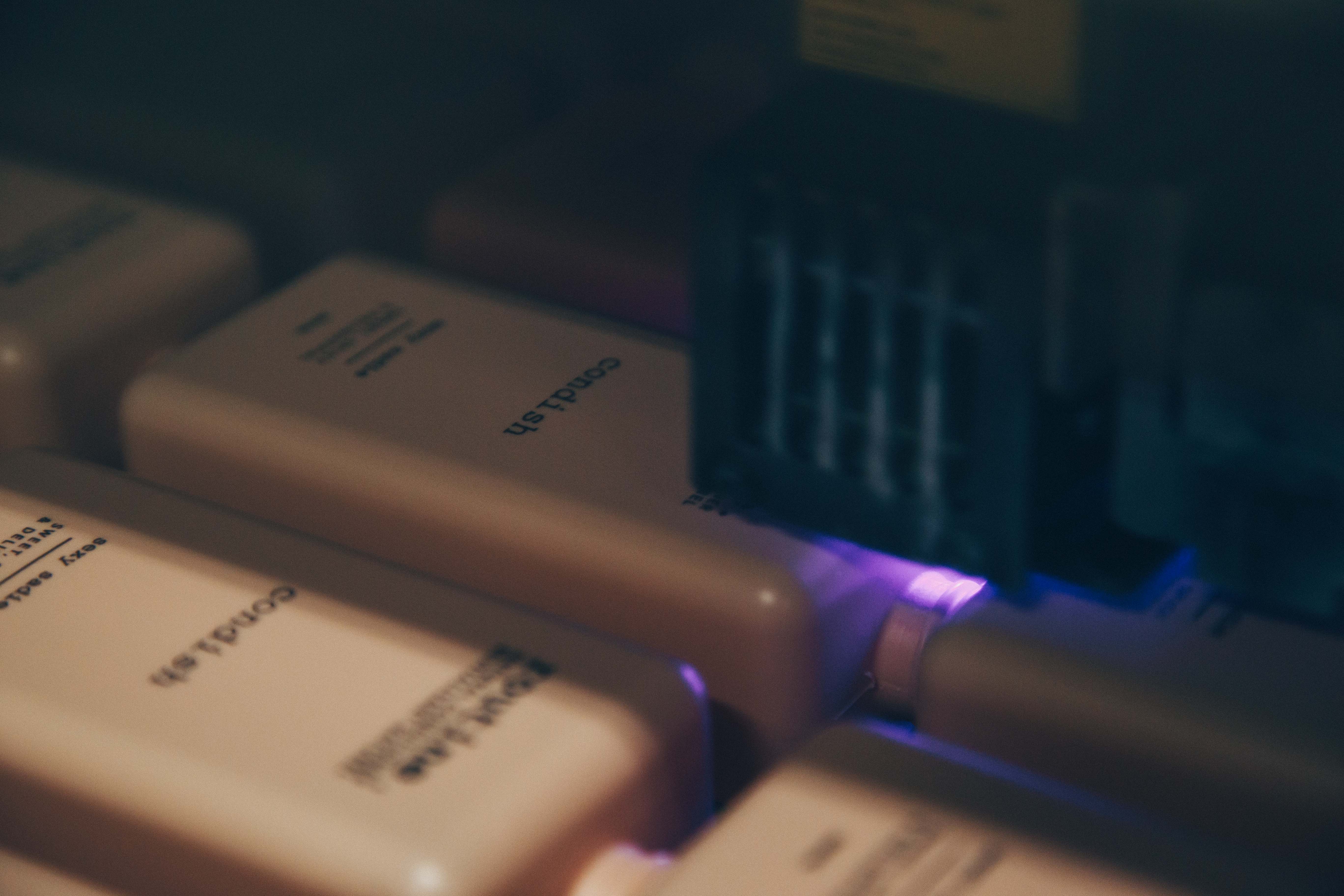 A close-up of a digital printing device printing labels on shampoo bottles for Routine Natural Conditioner.