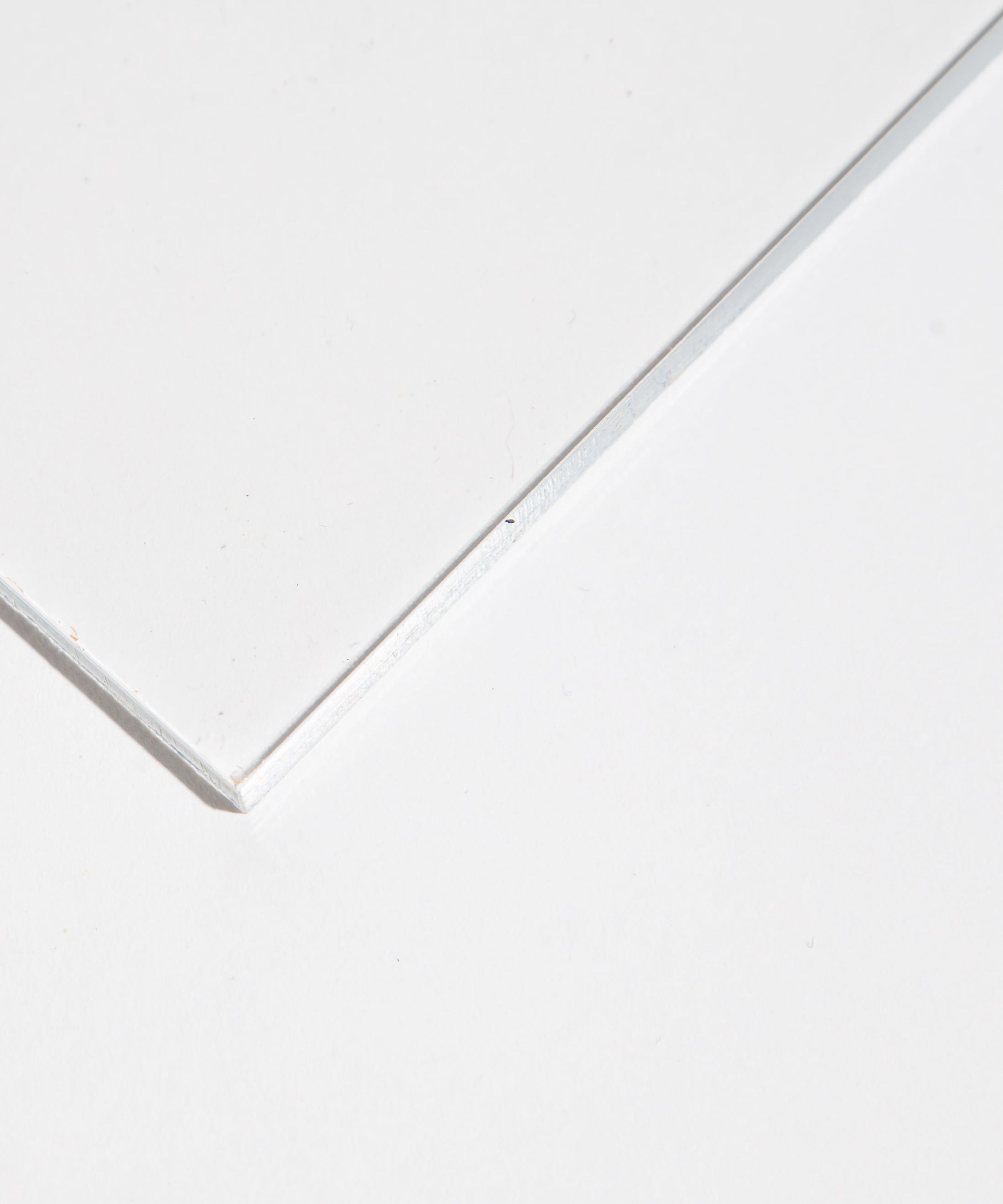 Close-up of a glass corner on a flat surface.