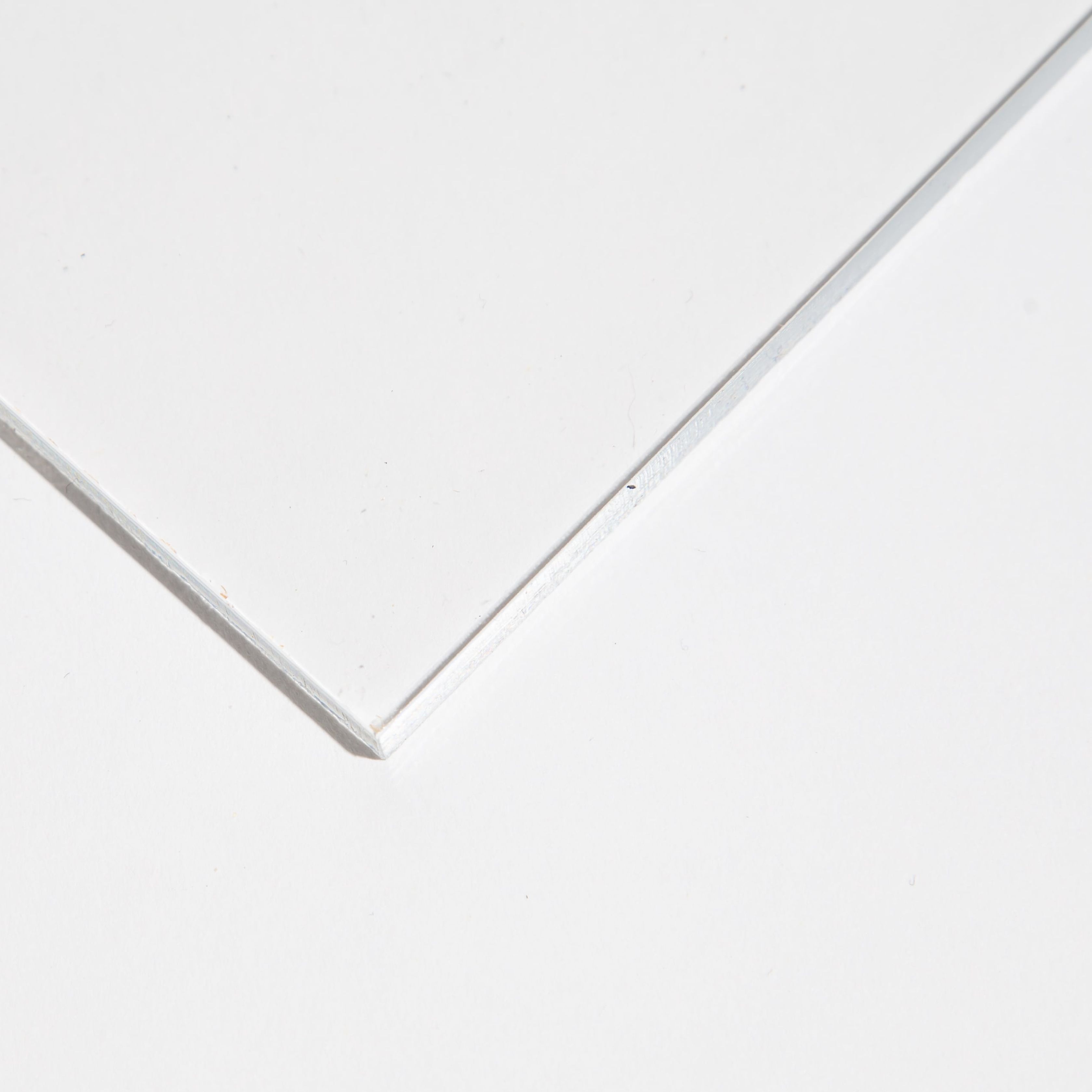 Close-up of a glass corner on a flat surface.