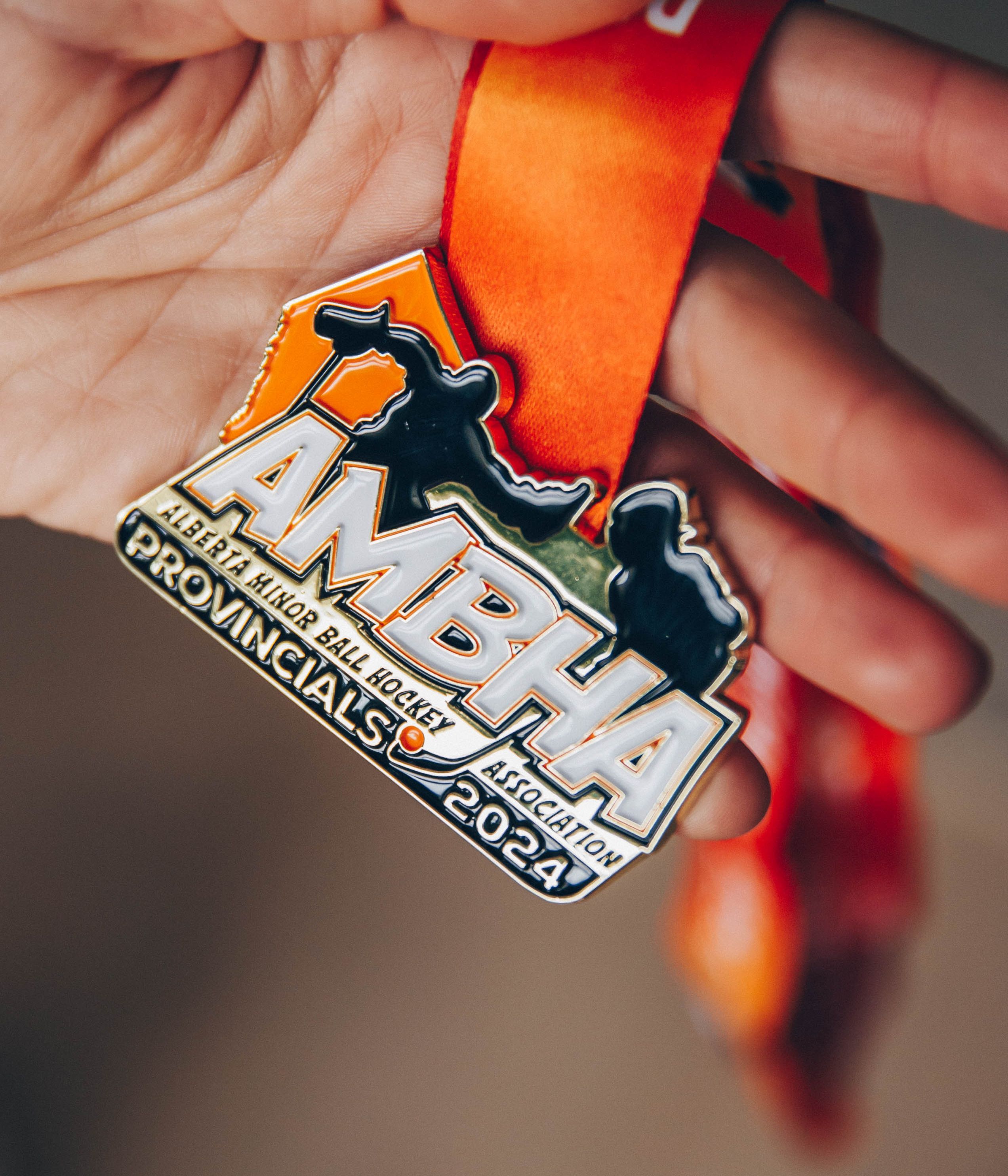 Vibrant custom-designed Alberta Minor Ball Hockey Provincials 2024 medal with bold orange ribbon, perfect for youth and adult leagues.