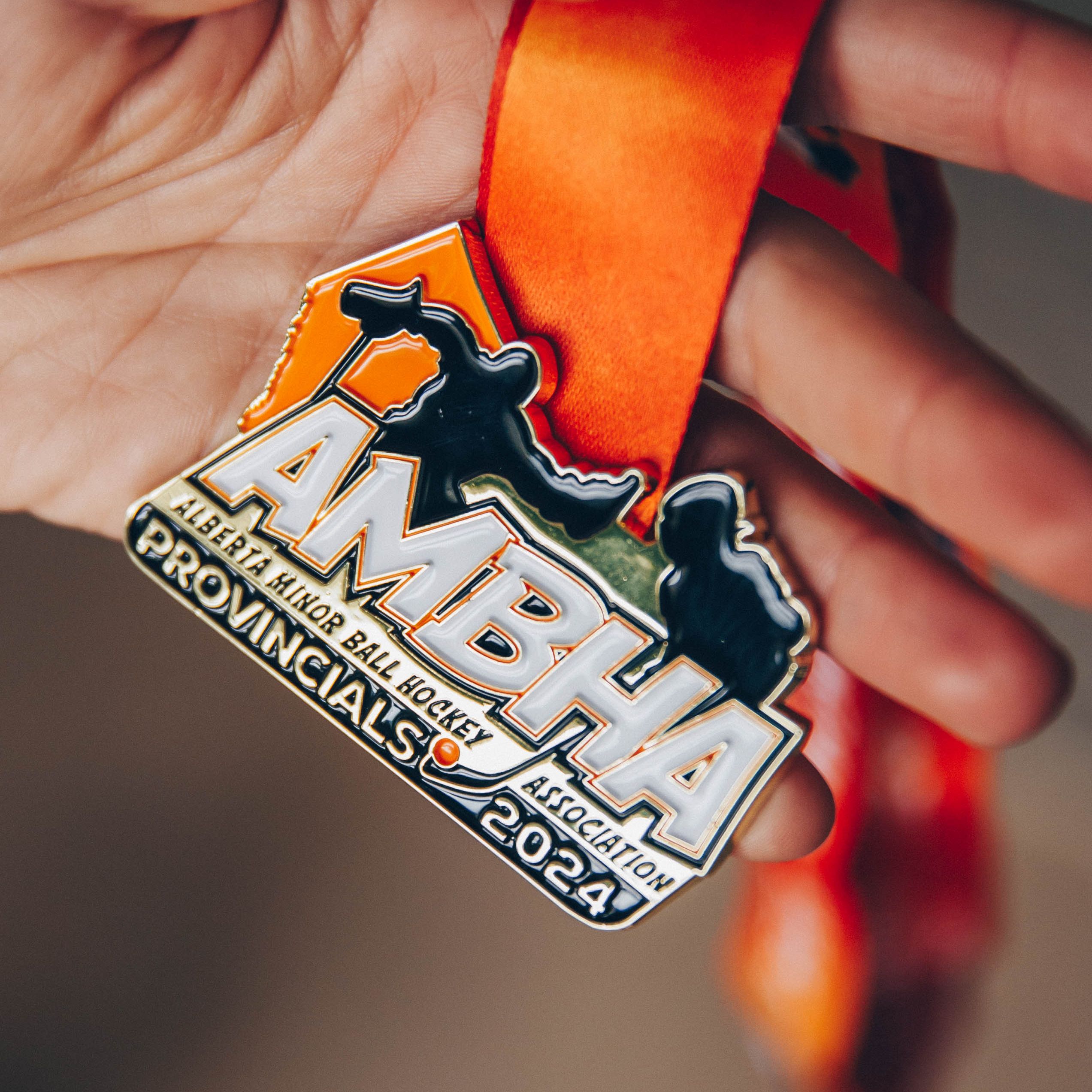 Vibrant custom-designed Alberta Minor Ball Hockey Provincials 2024 medal with bold orange ribbon, perfect for youth and adult leagues.