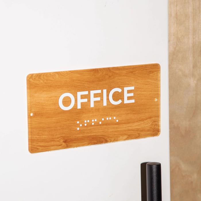 Wooden office sign with braille