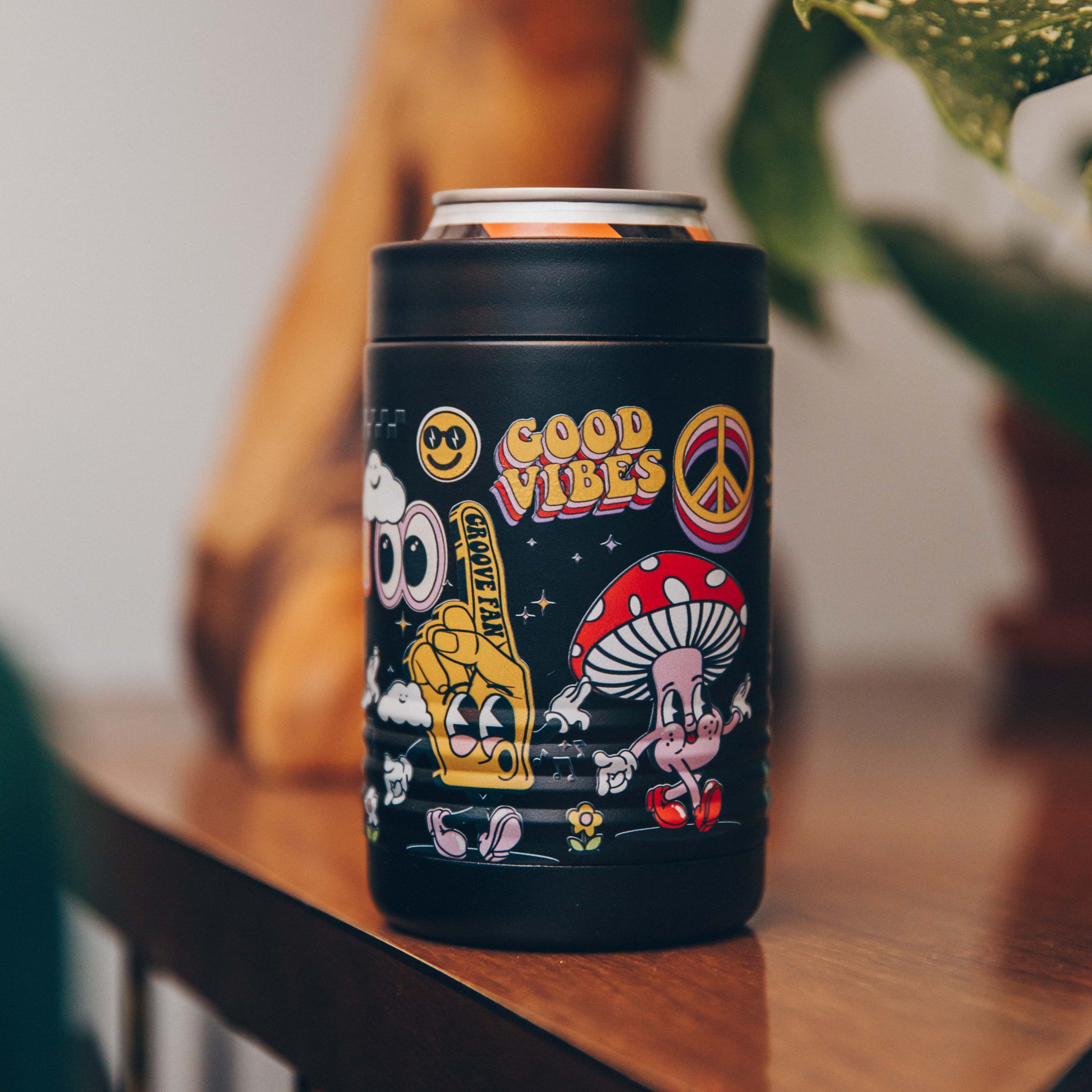 Black can holder with colorful retro designs and 'Good Vibes' text on a wooden table.