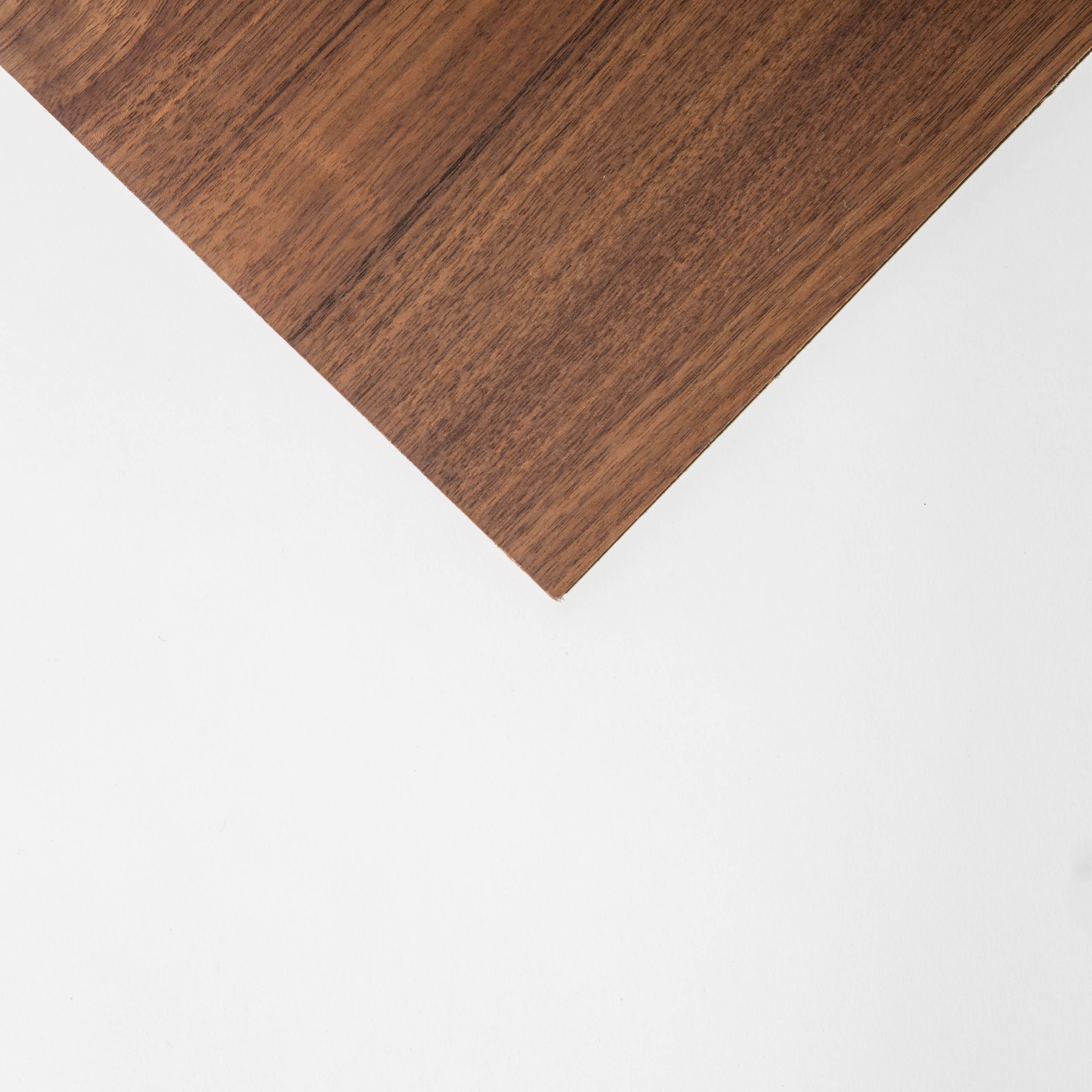 Diagonal wooden panel on a white background, showcasing natural grain and texture.
