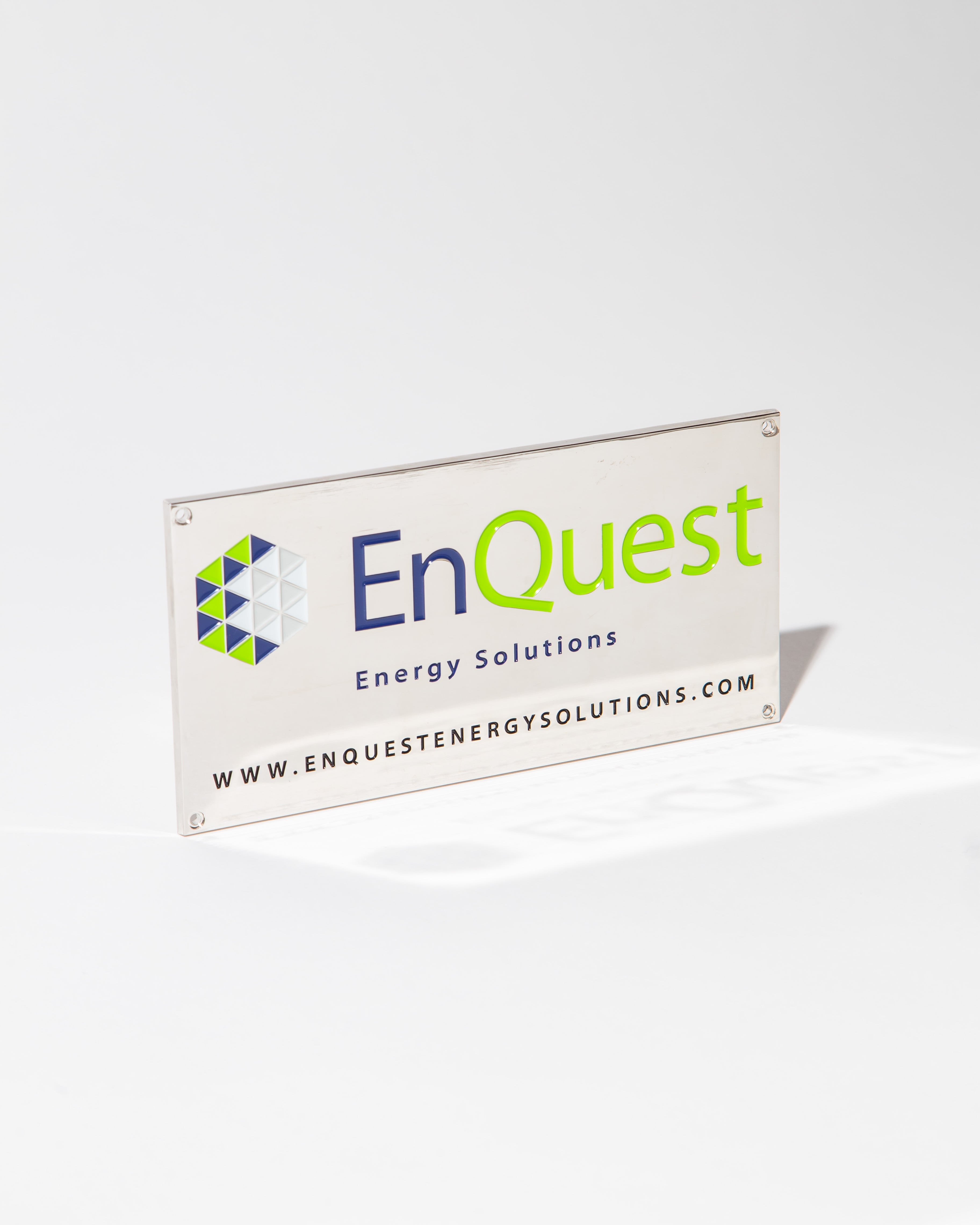 EnQuest Energy Solutions sign with logo and website URL on a white background.