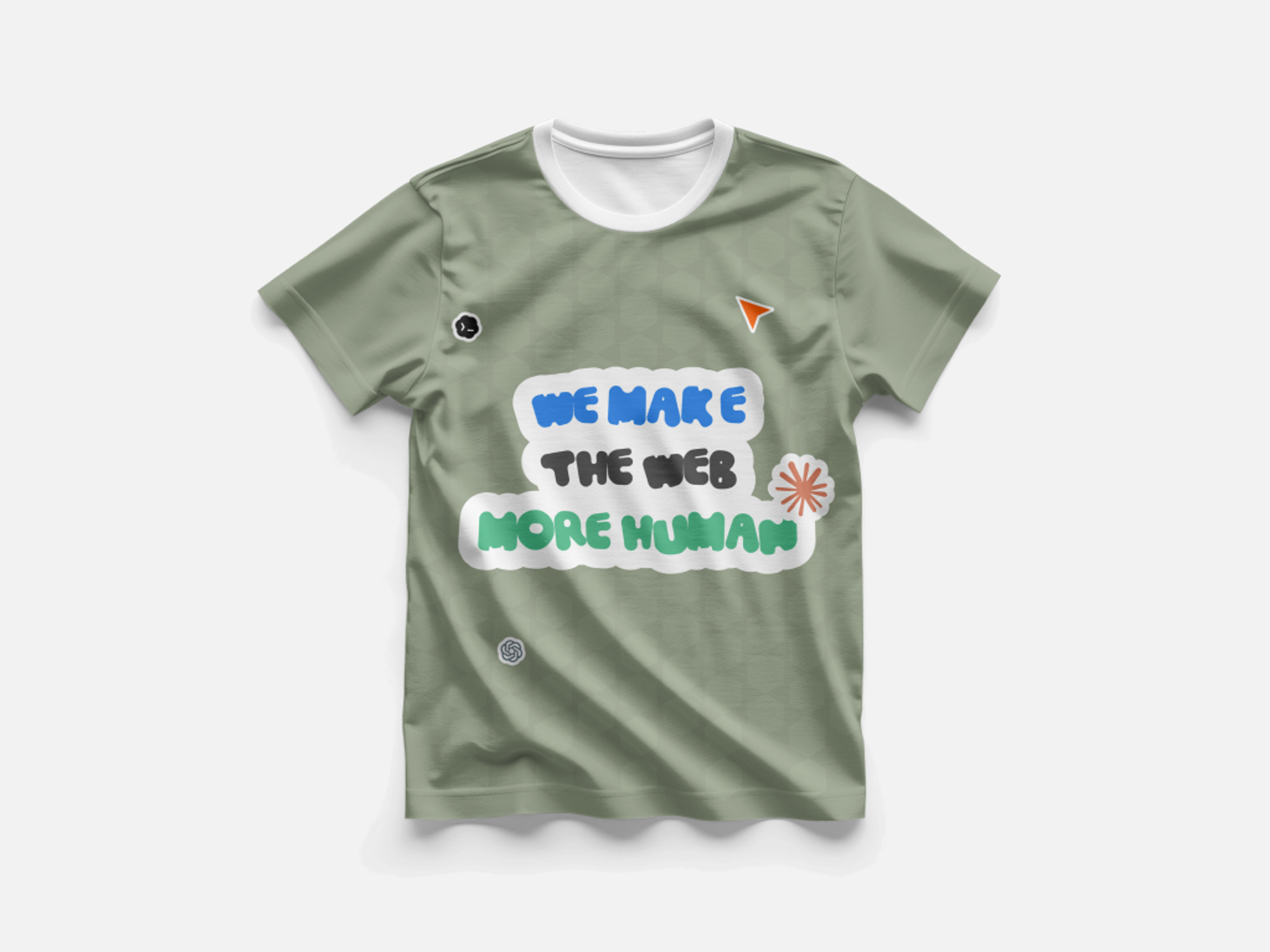 “We make the web more human” in a hand-drawn sticker style, on a sage shirt
