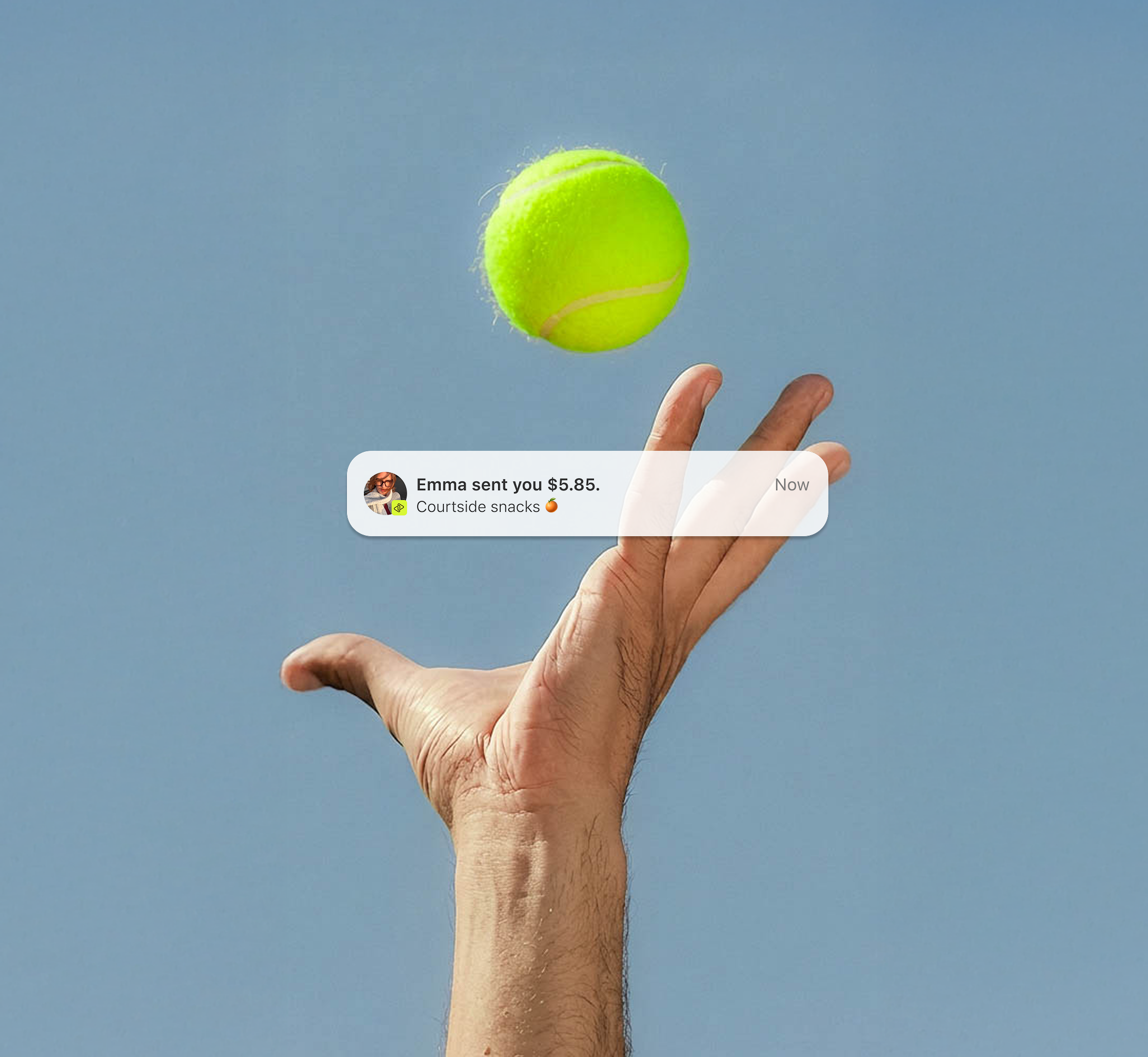 Tennis player's hand catching a ball.