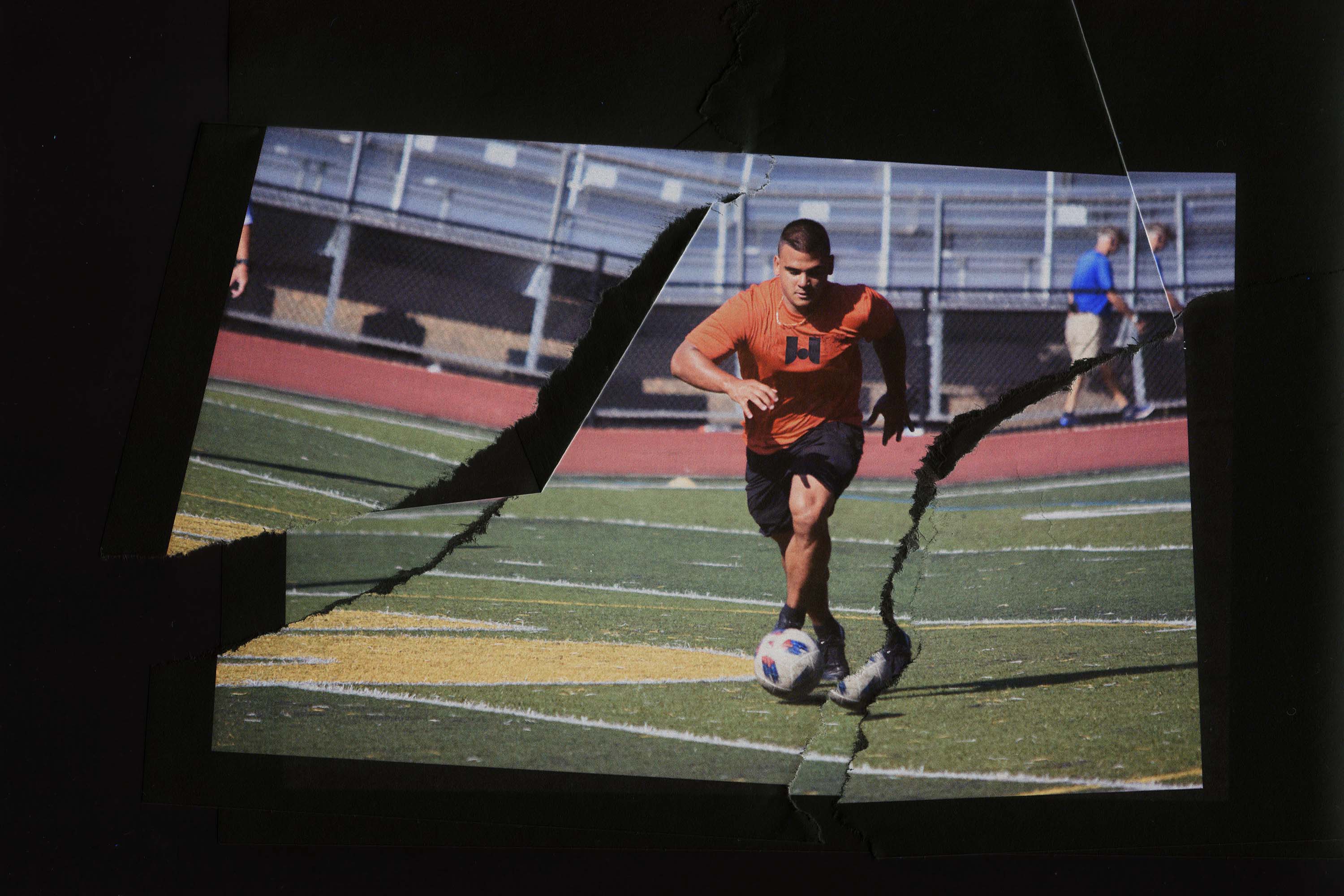 A soccer player dribbling the ball down the field