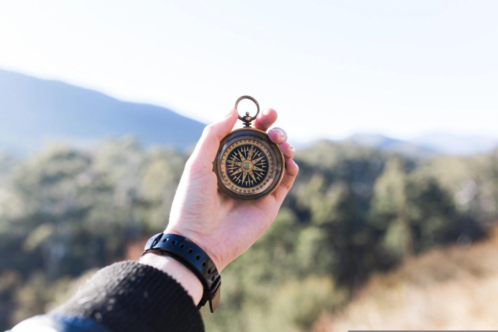 Kompass in einer Hand als Sinnbild für Spiritualität und Intuition als innerer Kompass