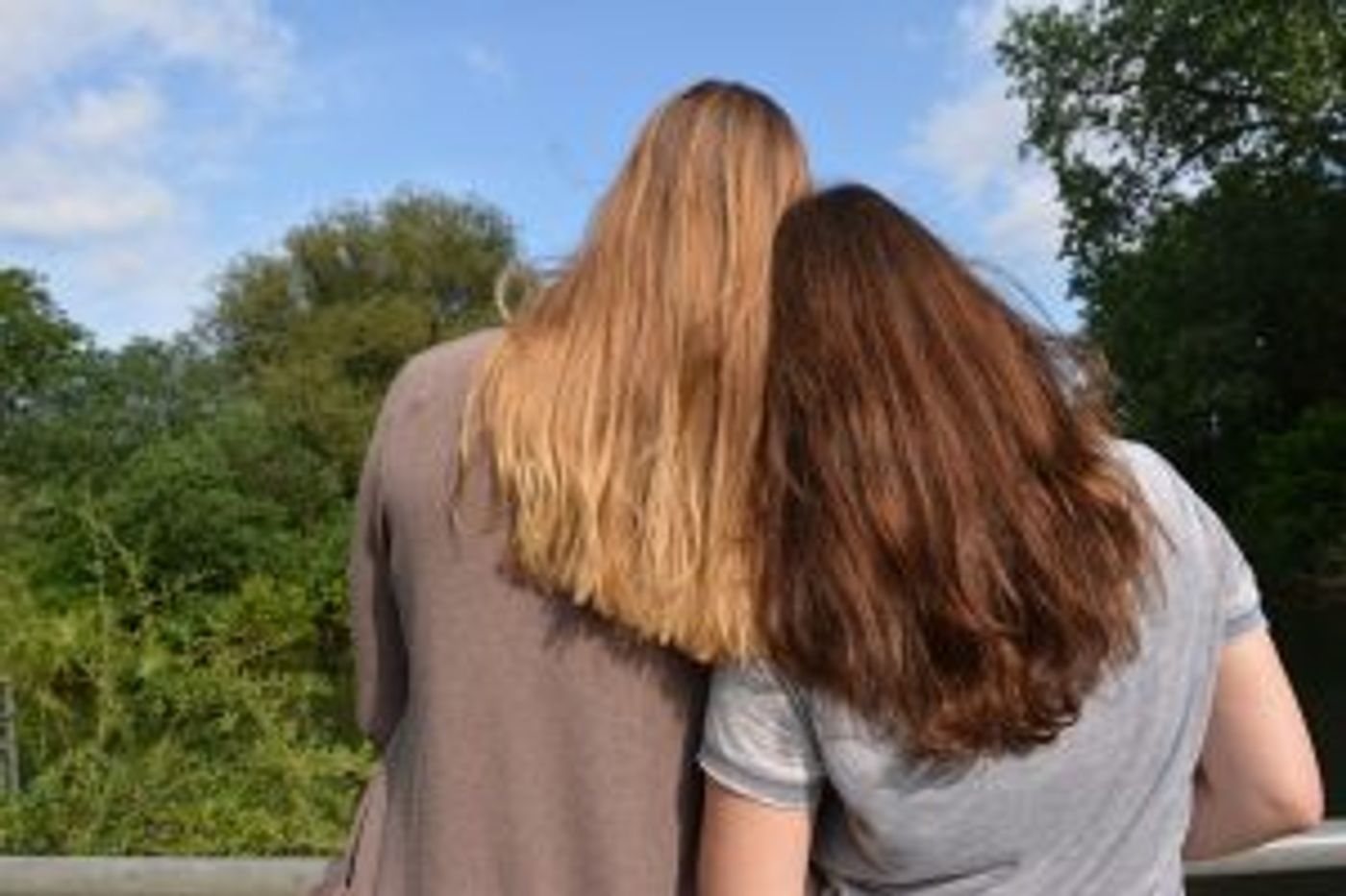 Zwei Frauen aneinander gelehnt von hinten