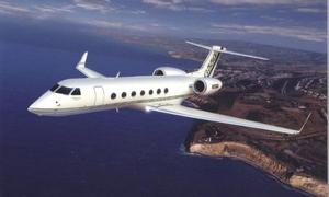 a private jet is flying over a body of water