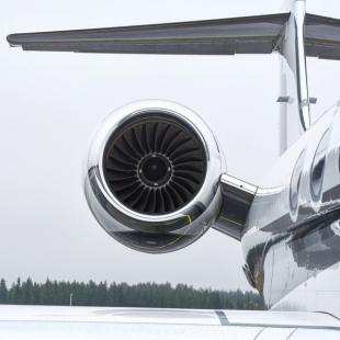 a close up of a private jet engine on a runway .