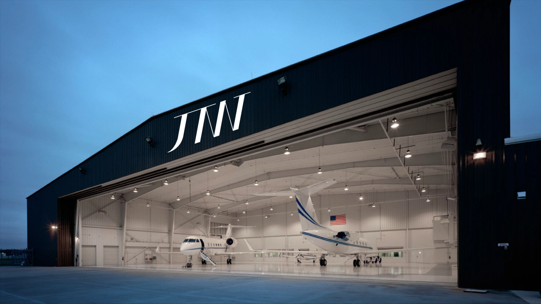 an airplane hangar with the word jnm on it