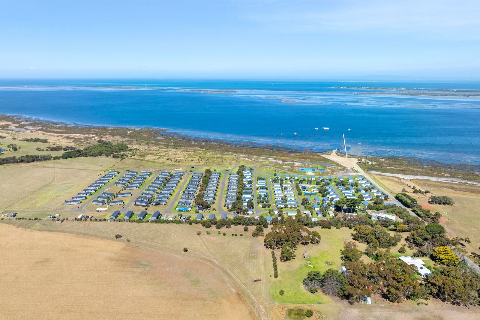 Swan Bay Holiday Park cabins and grounds beside the bay