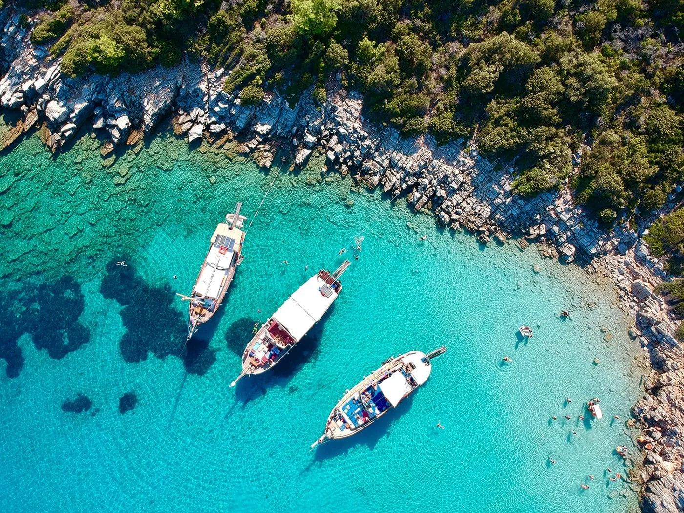 Turquoise bay with gulet boats and swimmers, Datça, Turkey