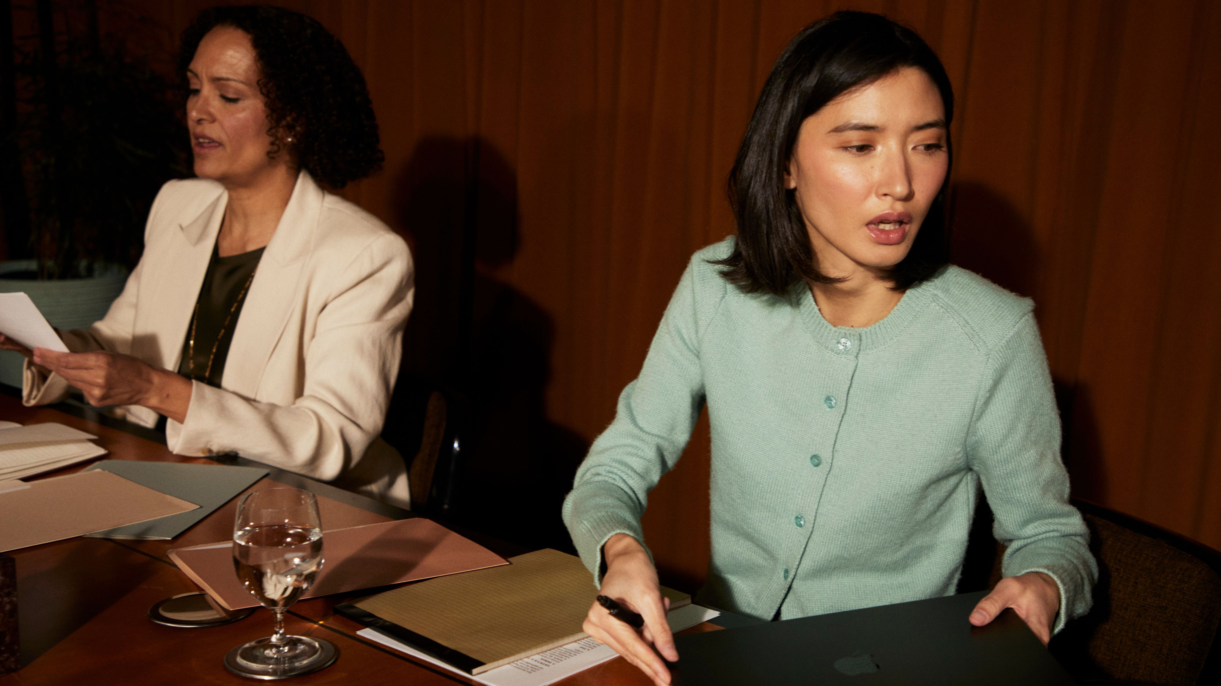 Two lawyers discussing and reviewing papers