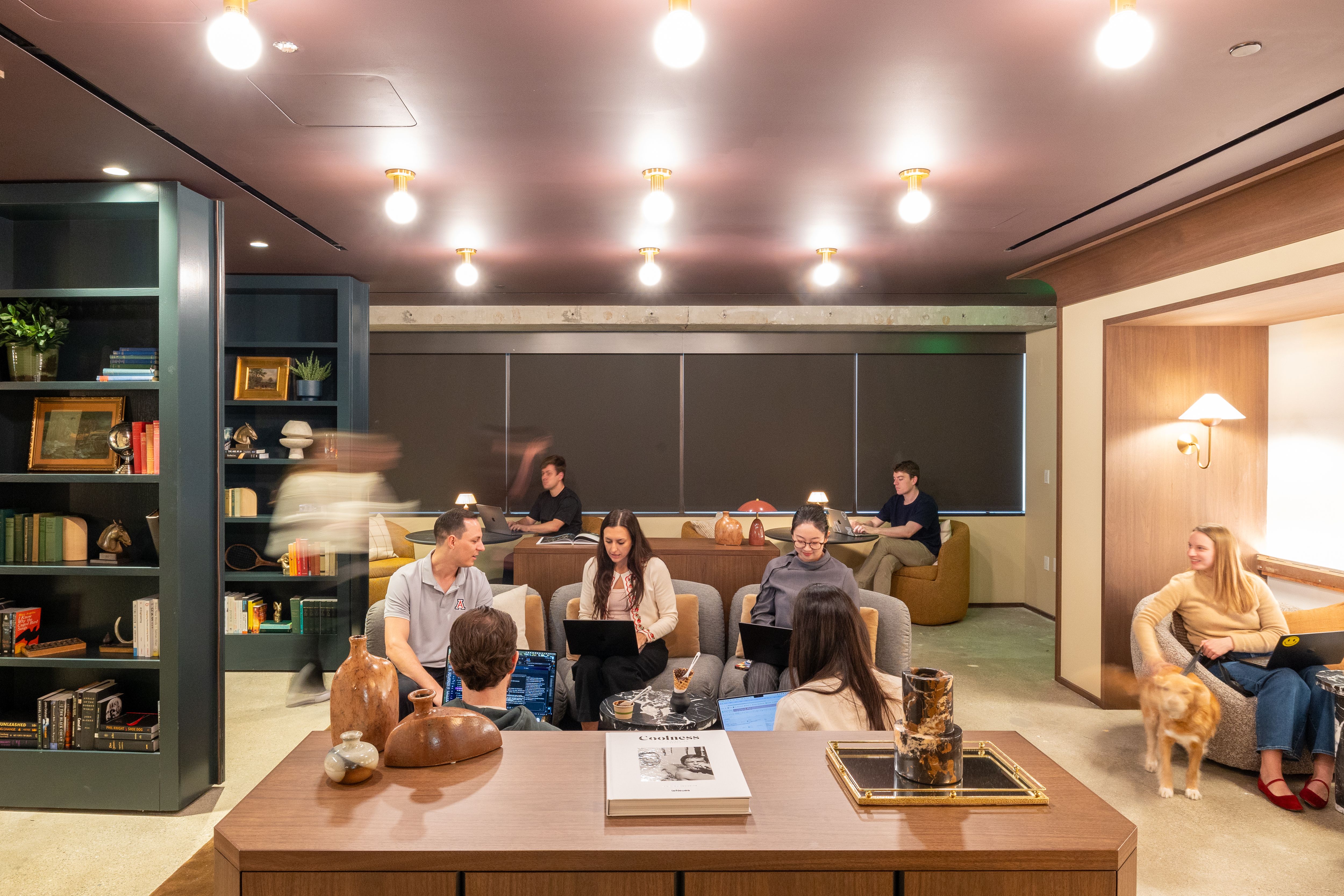 Harvey employees working in a warmly lit office lounge