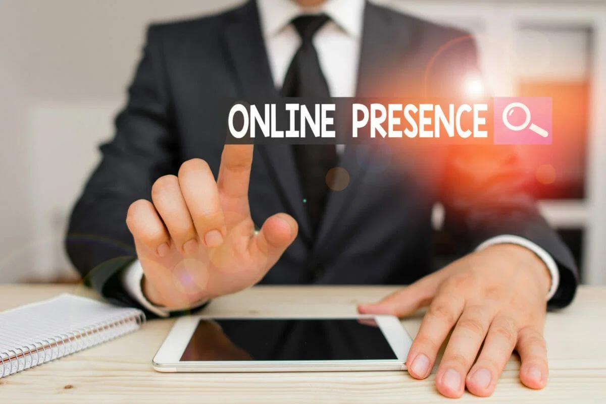 Businessman holding tablet with 'online presence' displayed on screen.