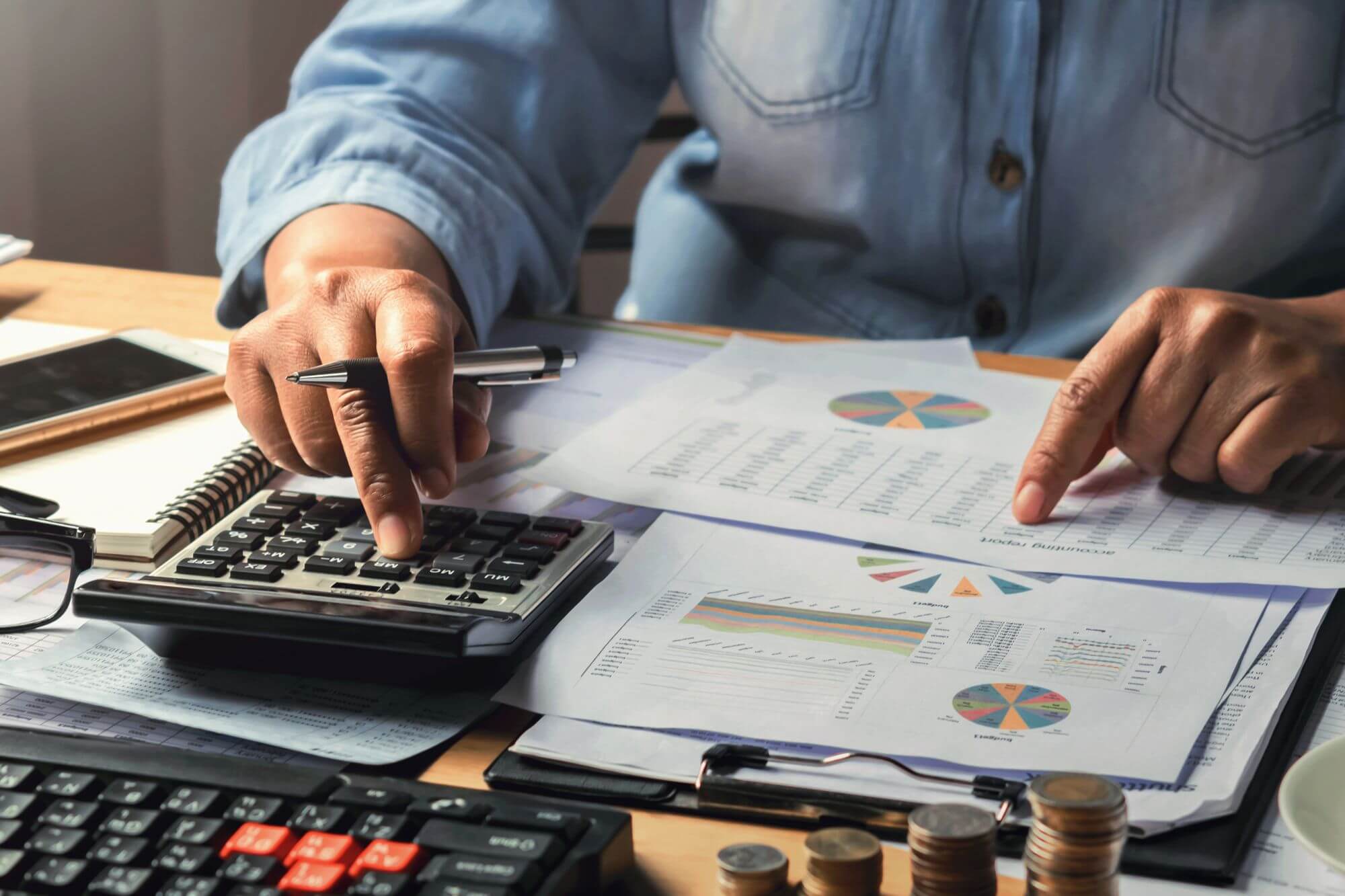 A man using a calculator for computing.