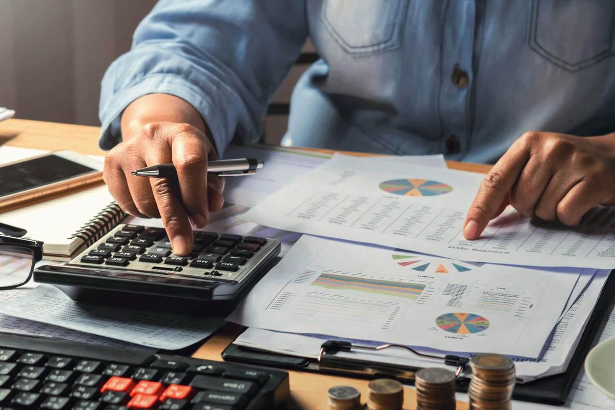 A man using a calculator for computing.