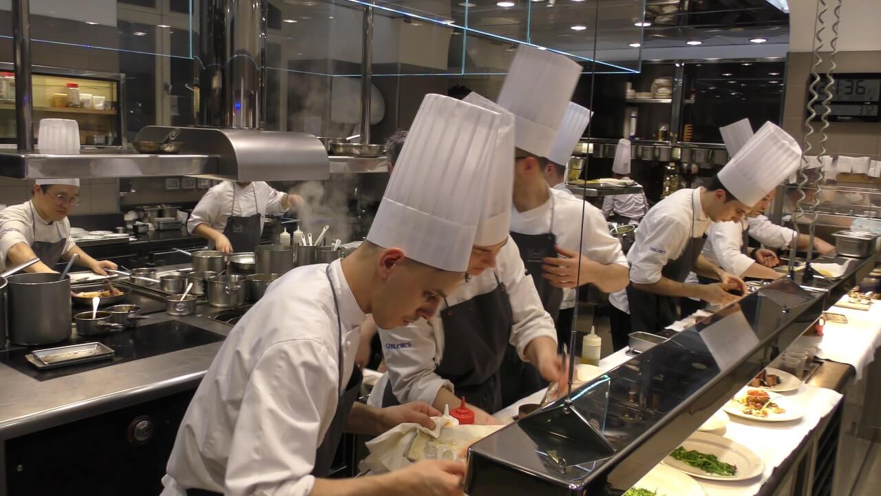 Busy chefs in a restaurant kitchen.