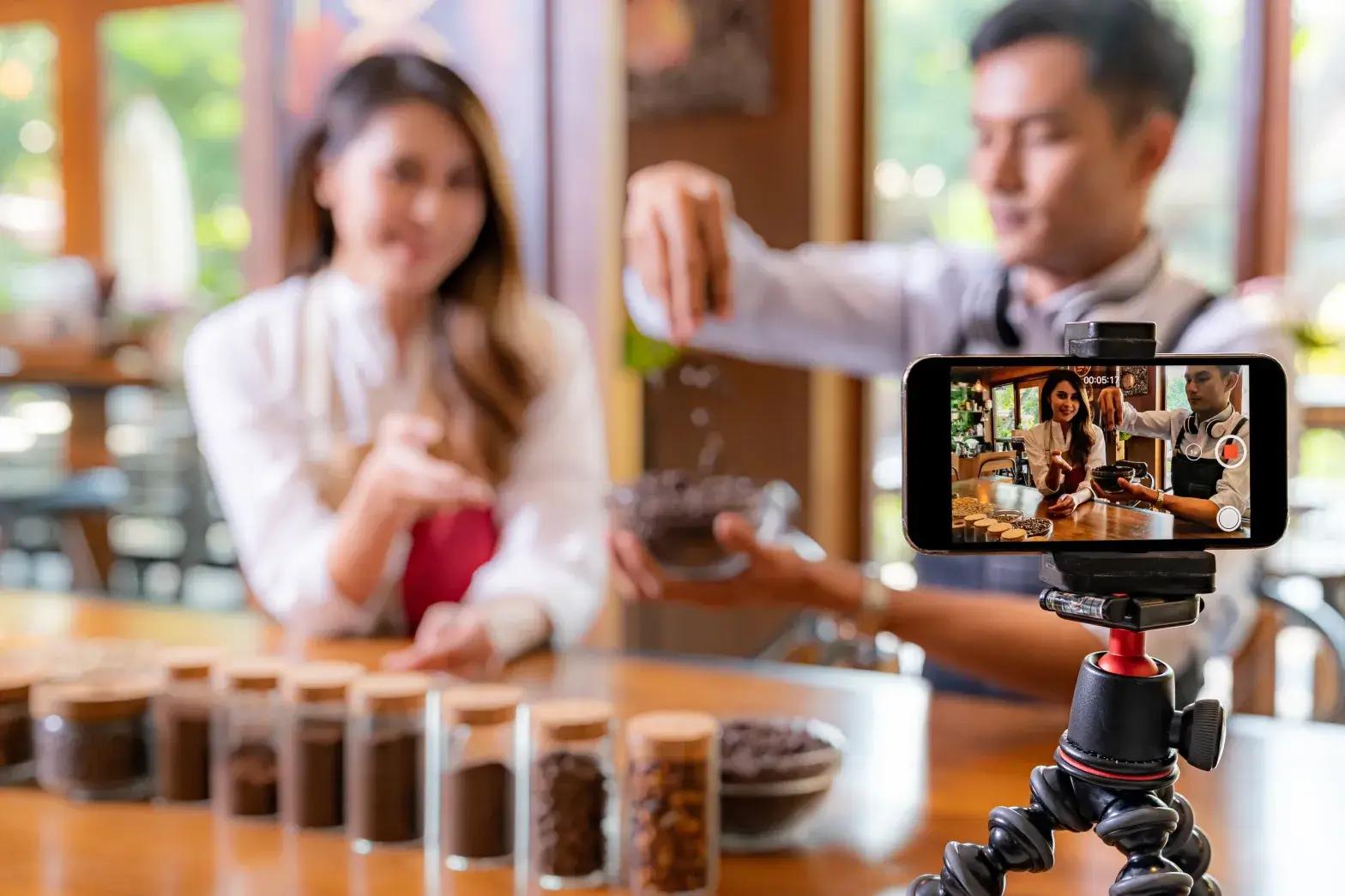 Man and woman recording a video together for social media content creation.