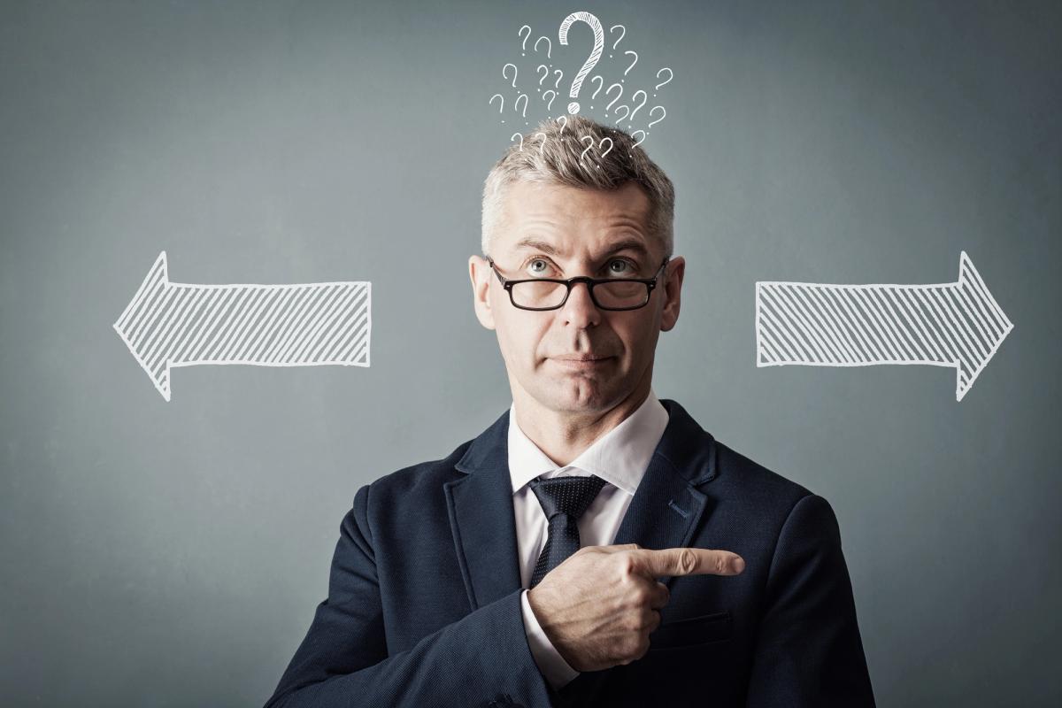 A man with a suit wearing an eyeglass is thinking carefully what to choose, a left and right arrow at the background and a number of question marks above his head.