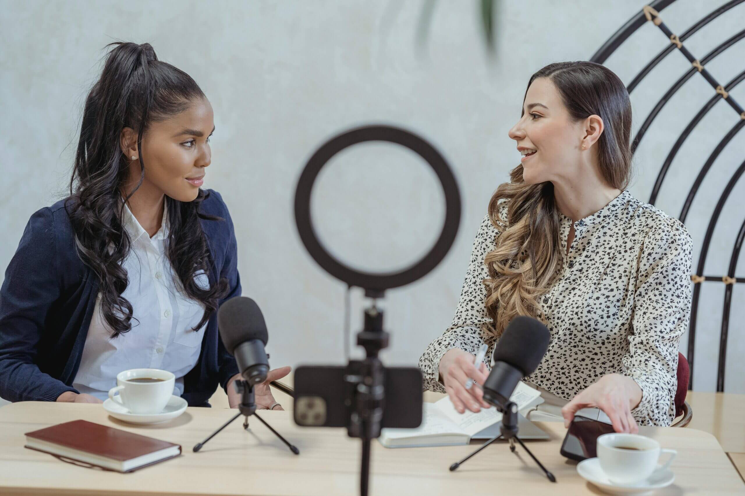 Two social media influencers collaborating to film a video together.