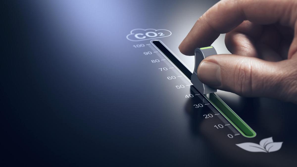 A man's finger pushing a lever up indicating an increase in carbon dioxide.