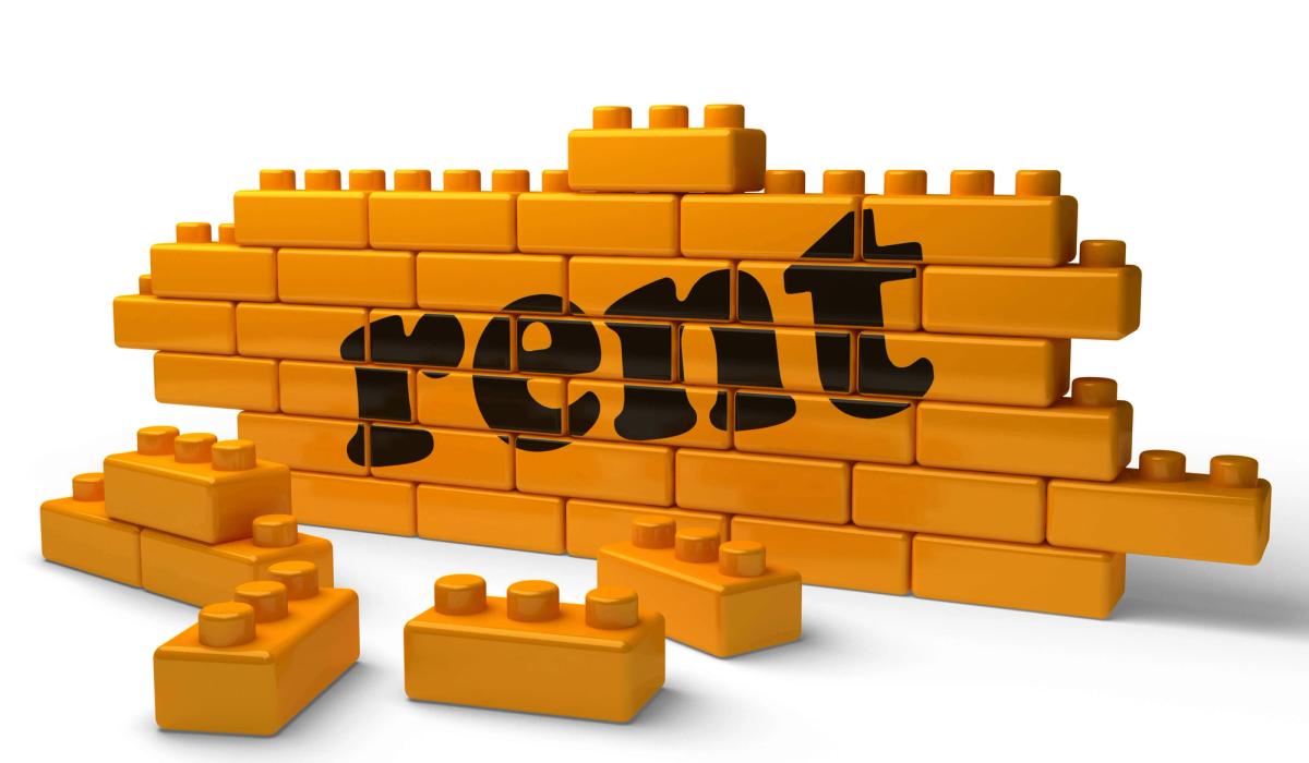 Rent word on yellow brick wall.