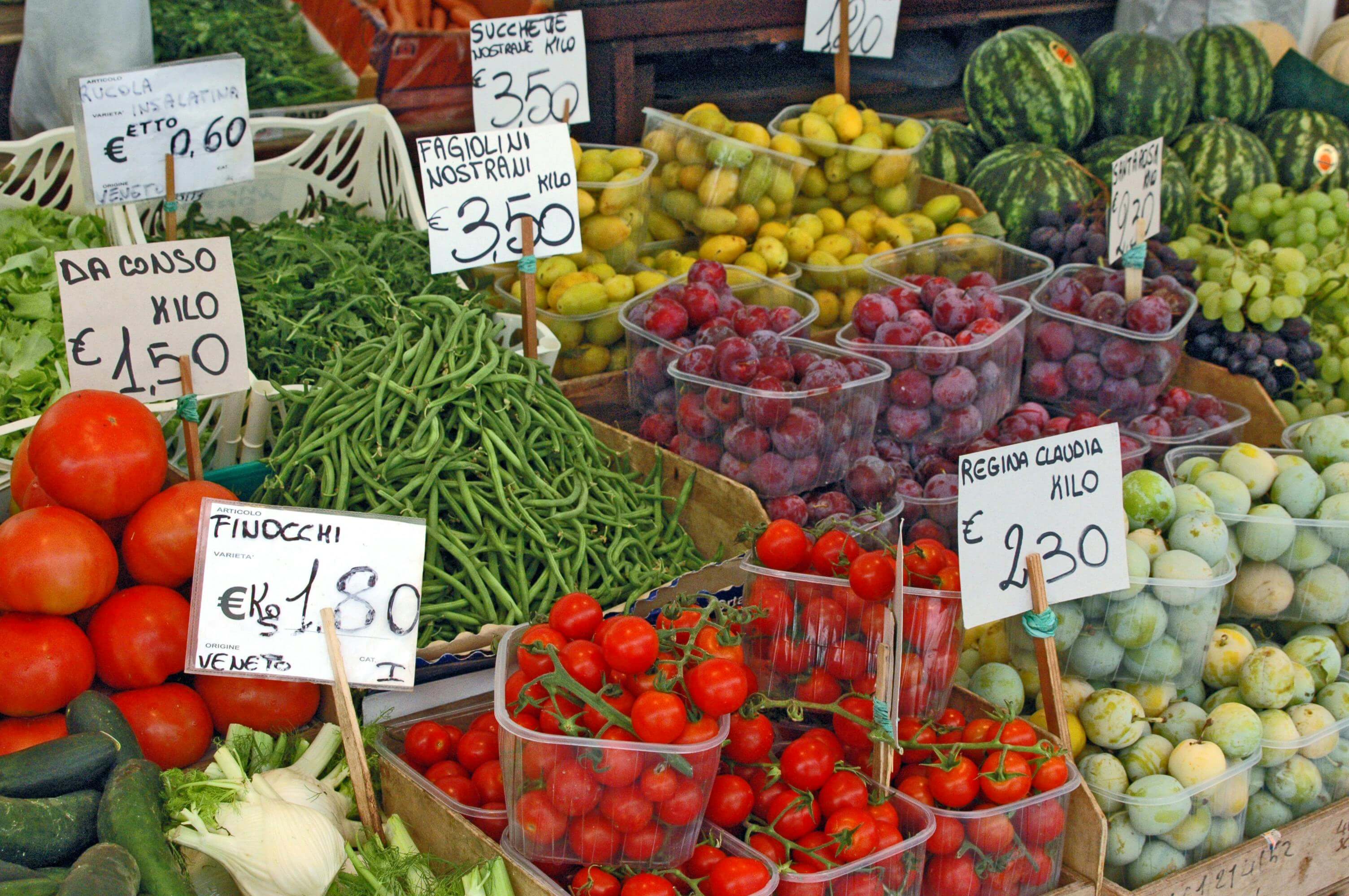 Various fruits and vegetables at a fruit stand.