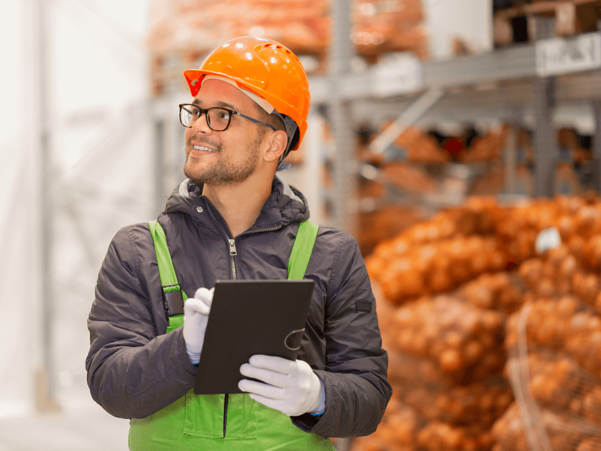 A man doing inventory, holding a tablet.