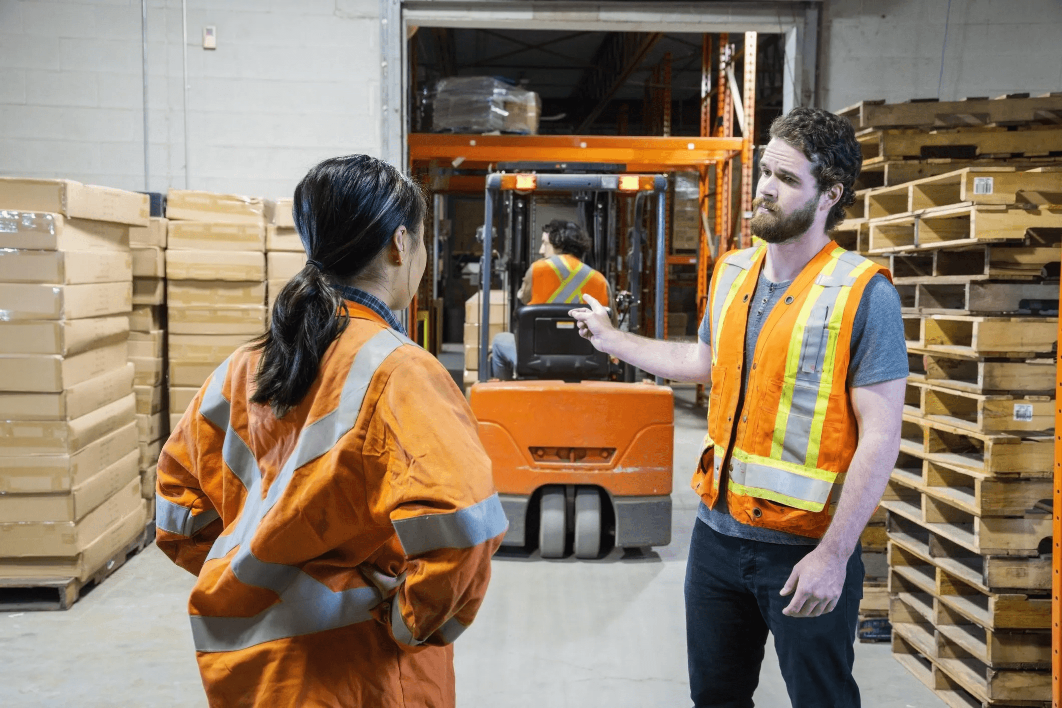 A man and a woman arguing in the warehouse.