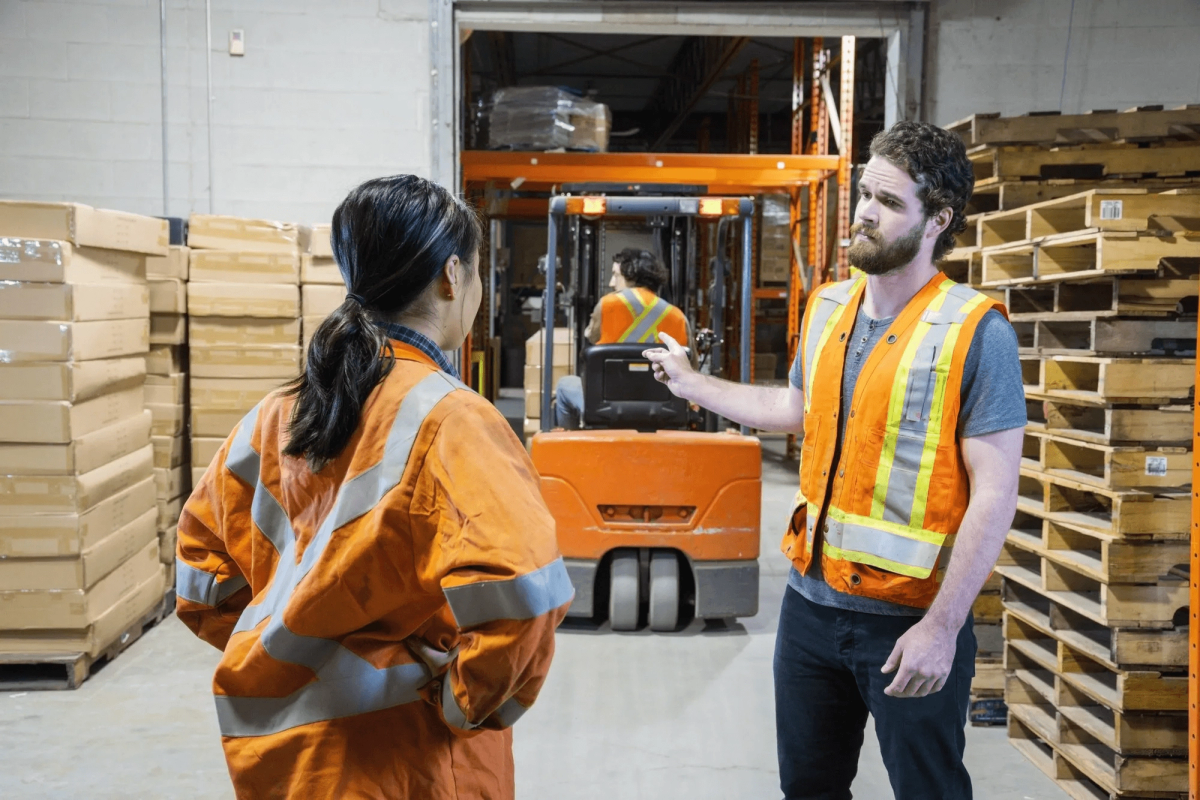 A man and a woman arguing in the warehouse.