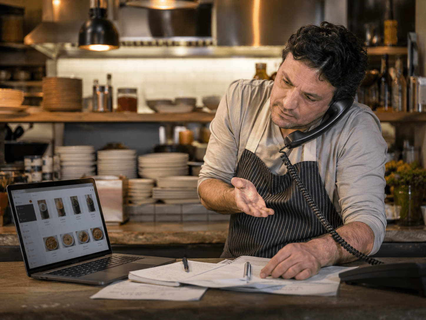 Restaurant operator placing an order by phone.
