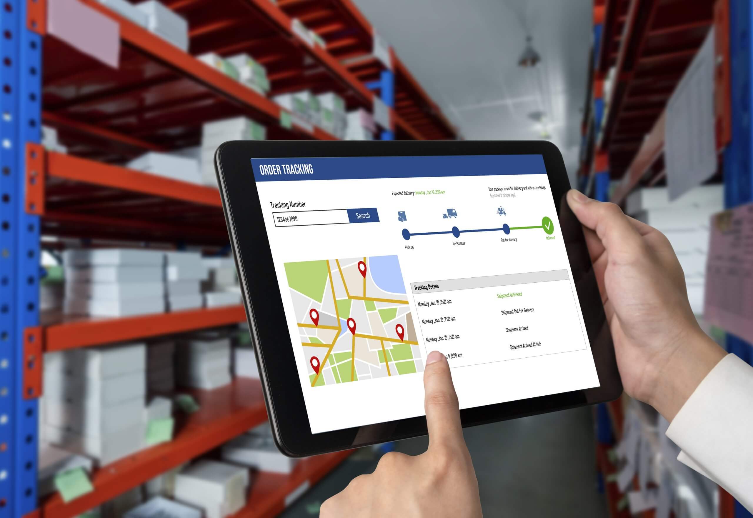 Tablet showing order tracking software in a warehouse.