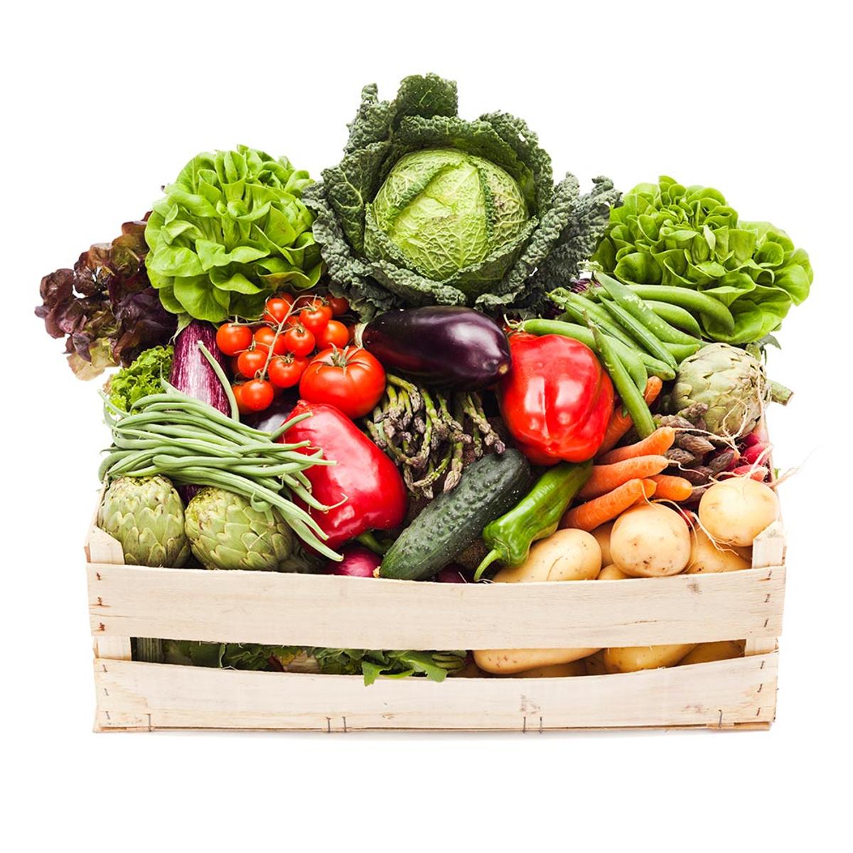 Assorted fresh vegetables, such as carrots, tomatoes, and lettuce, packed carefully in a wooden crate. 