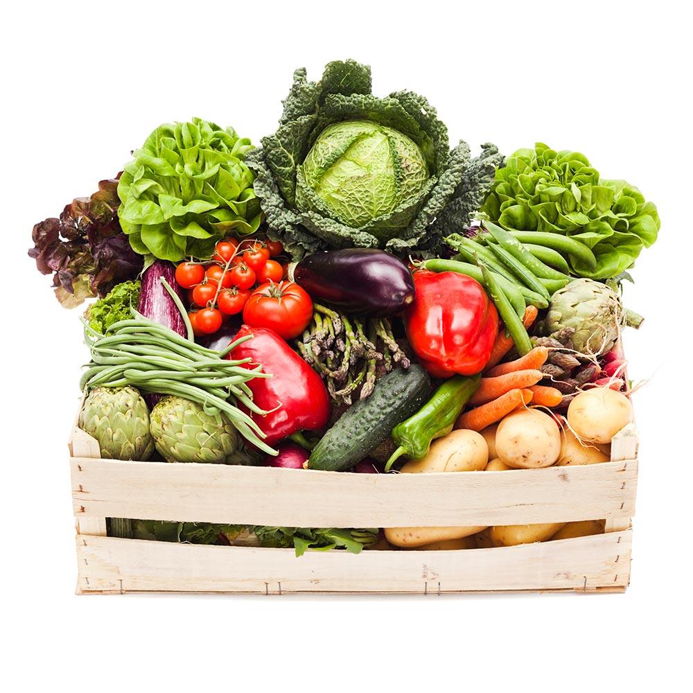 Assorted fresh vegetables, such as carrots, tomatoes, and lettuce, packed carefully in a wooden crate.