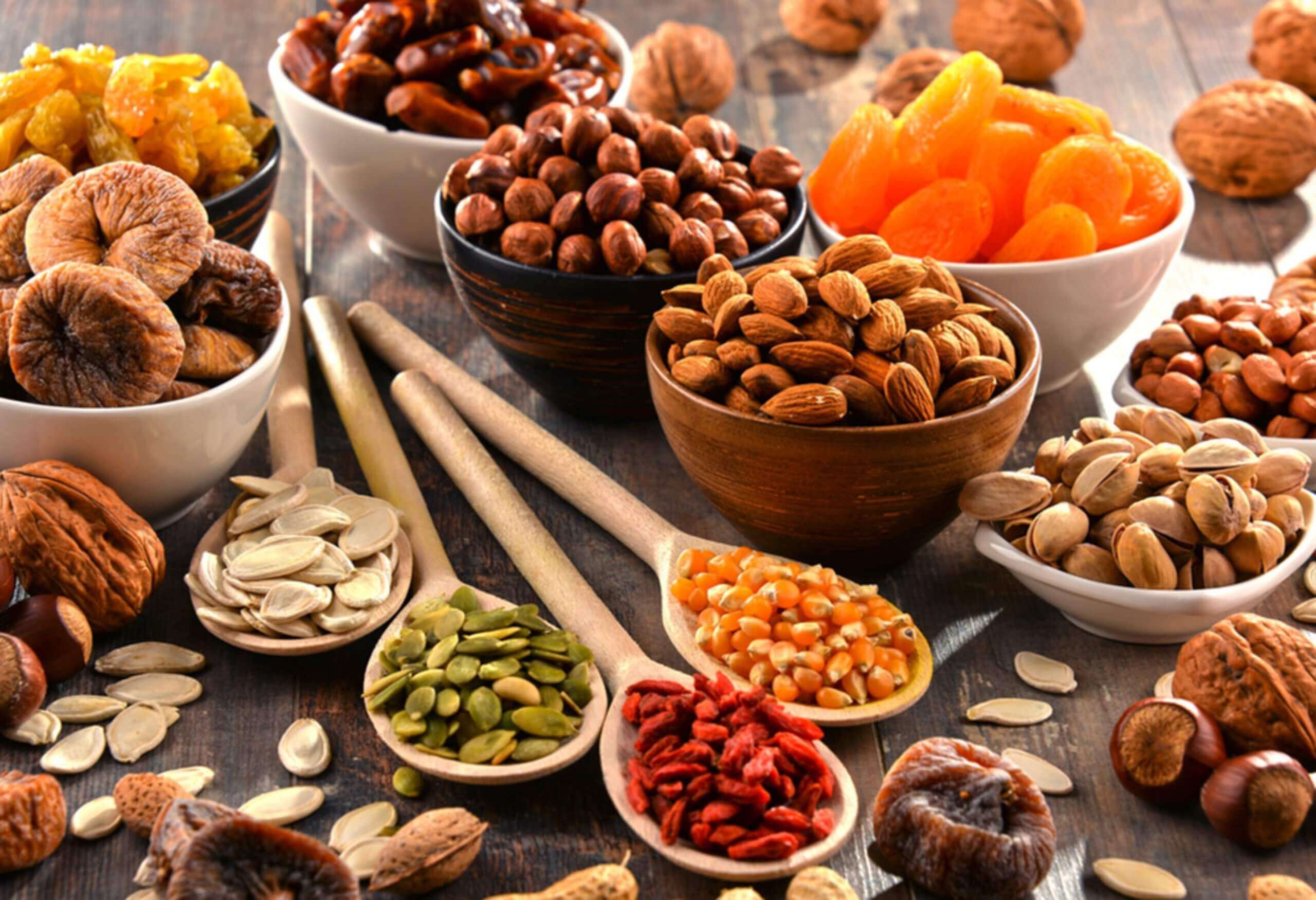 Variety of nuts and dried fruits together.