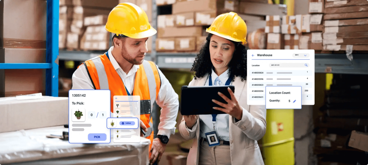 A man and a woman wearing yellow hard hat, discussing in a warehouse about digital inventory.