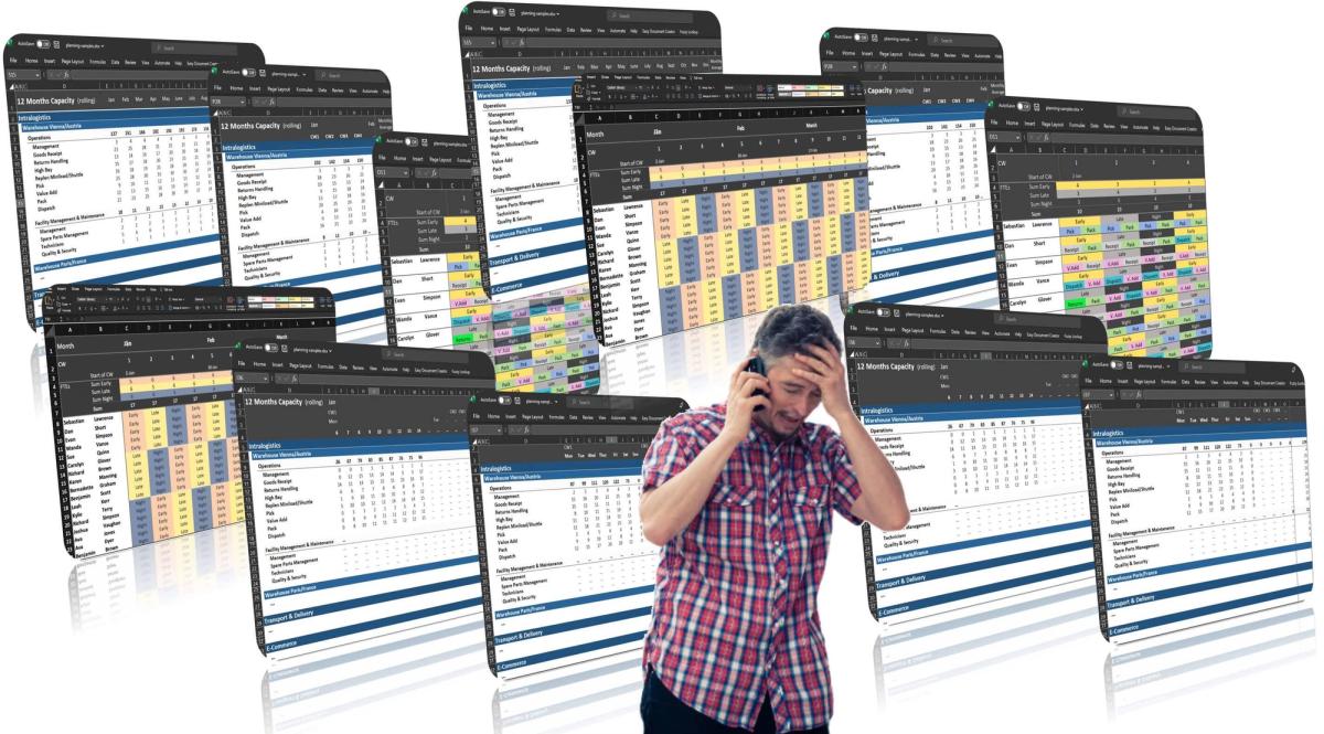 A problematic man talking on the phone with spreadsheets on the background.