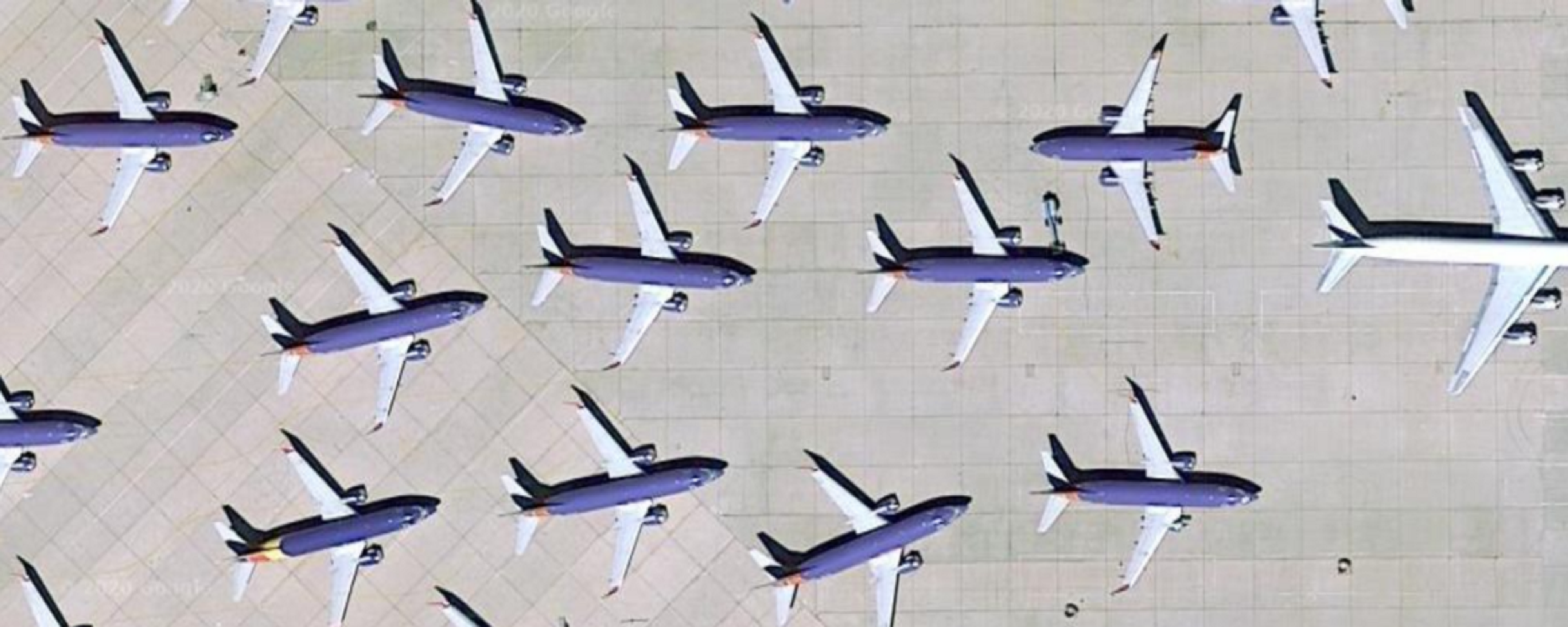  A group of airplanes parked on a runway